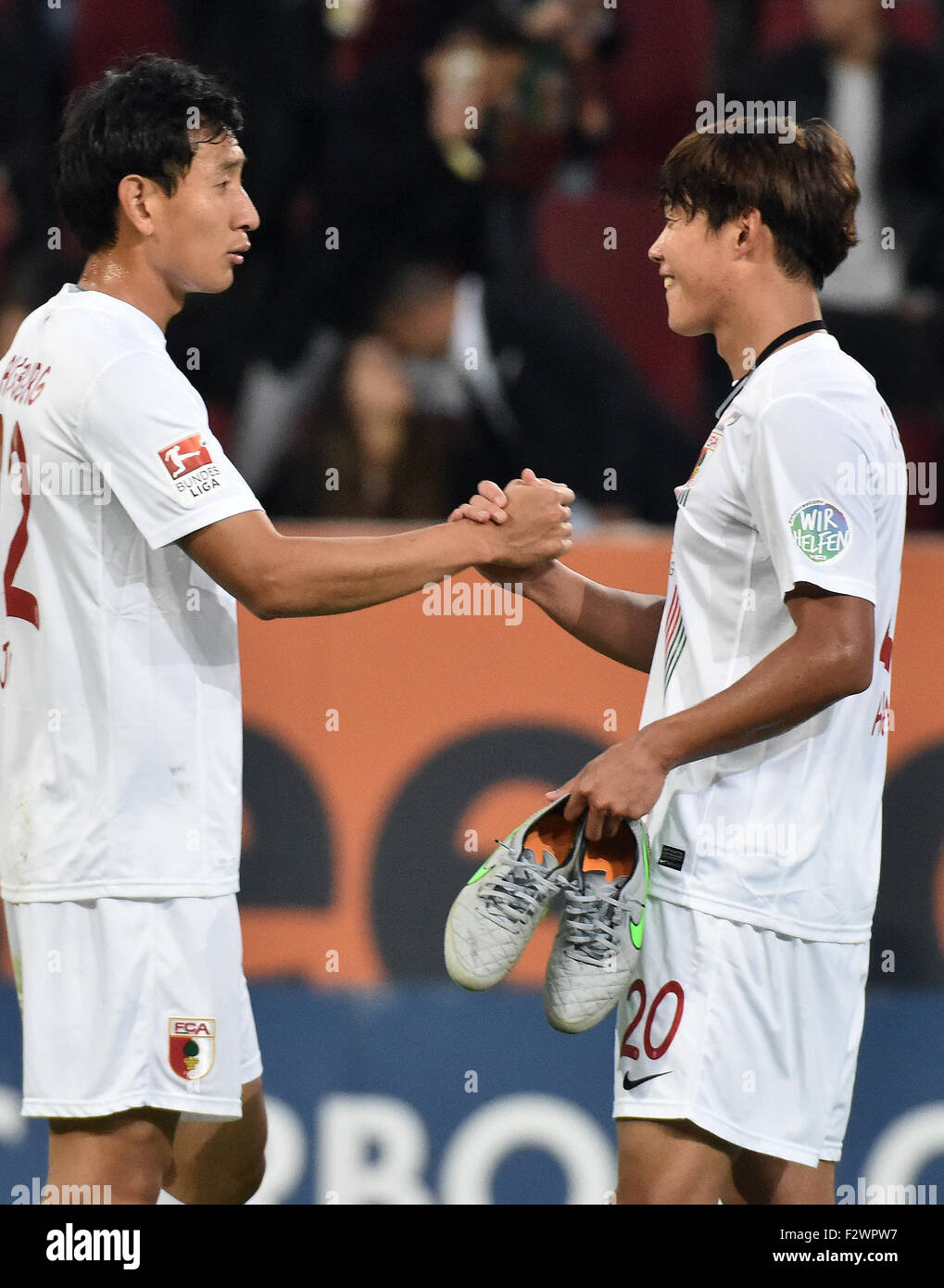 Augsburg, Germany. 20th Sep, 2015. Augsburg's Ji Dong-Won (l) and Hong Jeong-Ho celebrate their team's 2-0 victory after the German Bundesliga soccer match between FC Augsburg and Hannover 96 in Augsburg, Germany, 20 September 2015. Photo: Stefan Puchner/dpa/Alamy Live News Stock Photo