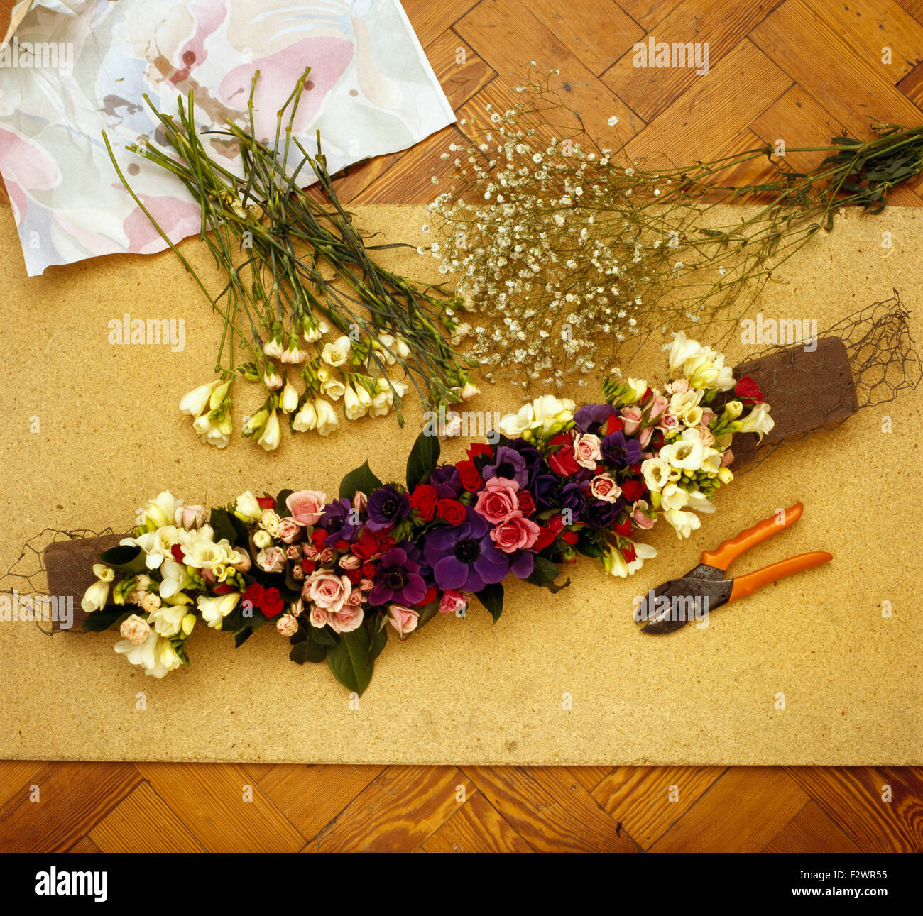 Making a fresh flower garland Stock Photo Alamy
