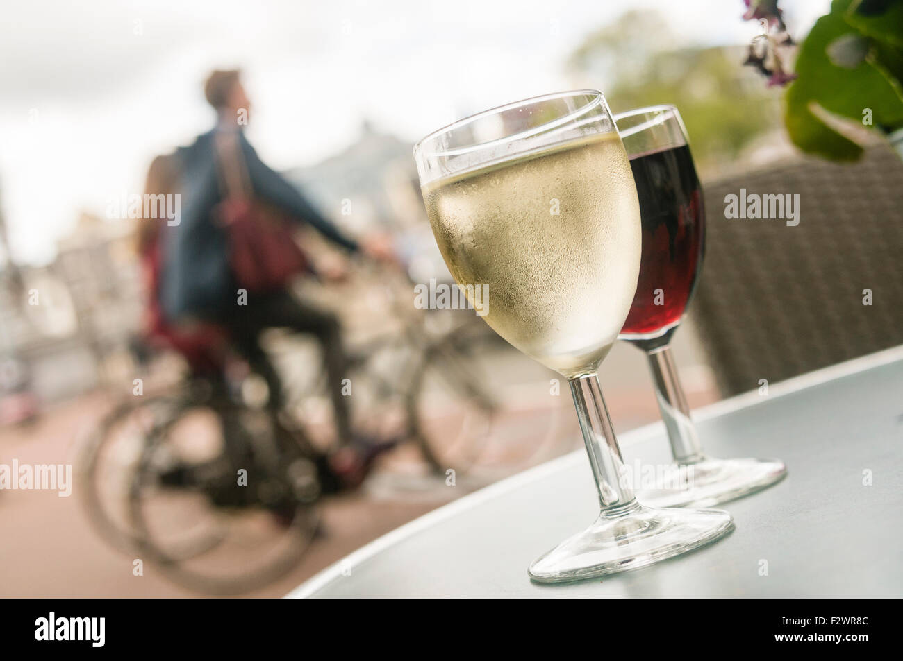 Glasses of white and red wine on a table outside a bar in Amsterdam