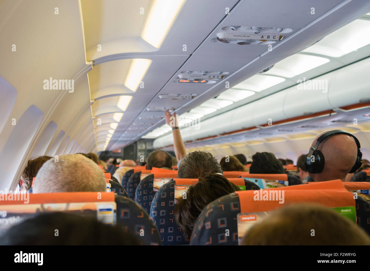 Passengers on board an easyJet flight Stock Photo - Alamy