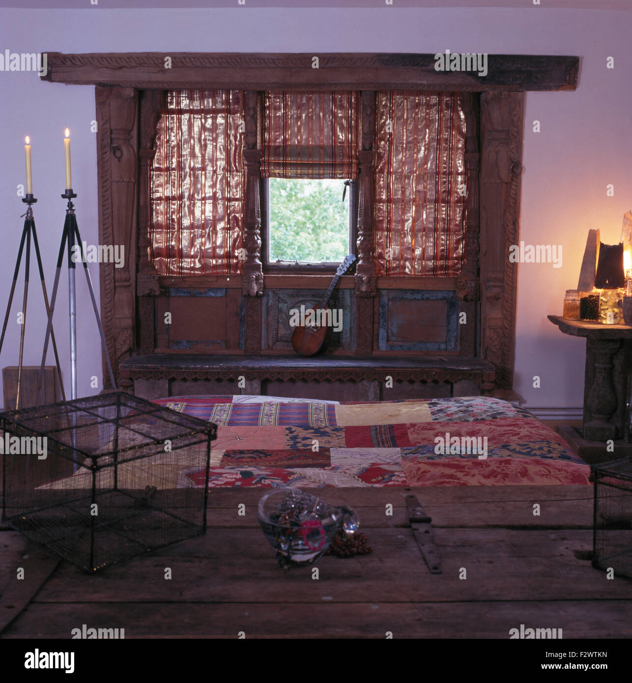 Metallic fabric blinds on rustic windows in ethnic style nineties barn ...