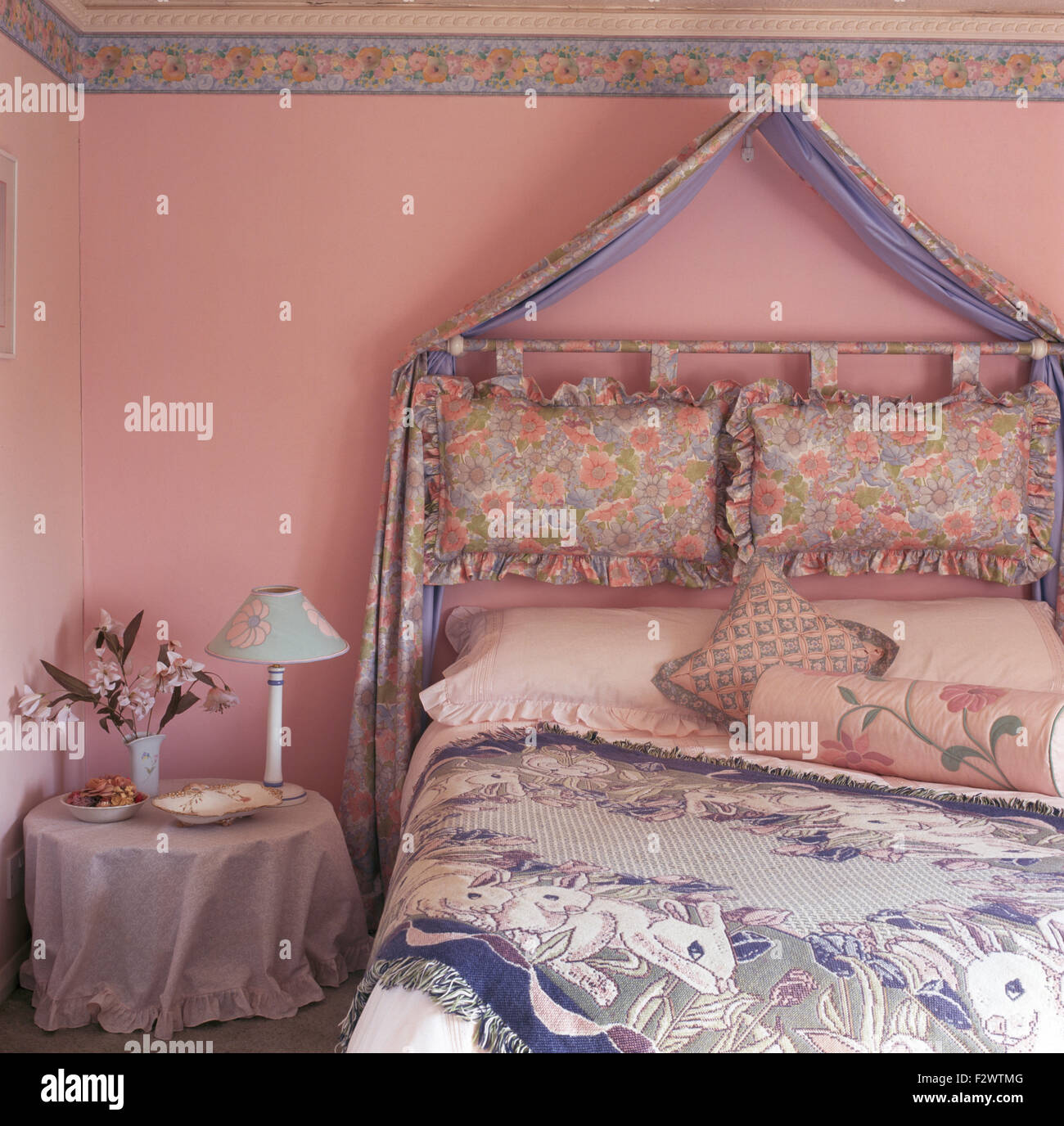 Draped Fabric Above Cushions Used As A Headboard On Wall Above Bed