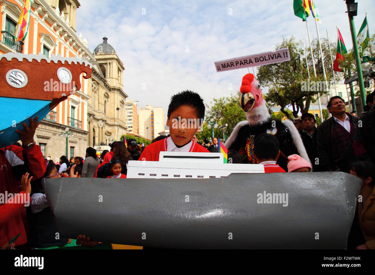 La Paz, Bolivia, 24th September 2015. A schoolboy holds a large model boat while awaiting the verdict of the International Court of Justice in The Hague in Plaza Murillo. Bolivia asked the ICJ in 2013 to demand that Chile negotiated access to the Pacific Ocean for Bolivia (Bolivia lost its coastal province to Chile during the War of the Pacific (1879-1884)). Chile raised an objection that the case wasn't within the ICJ's jurisdiction. The ICJ ruled (by 14 votes to 2) that it did have jurisdiction to hear the case. Credit:  James Brunker / Alamy Live News Stock Photo