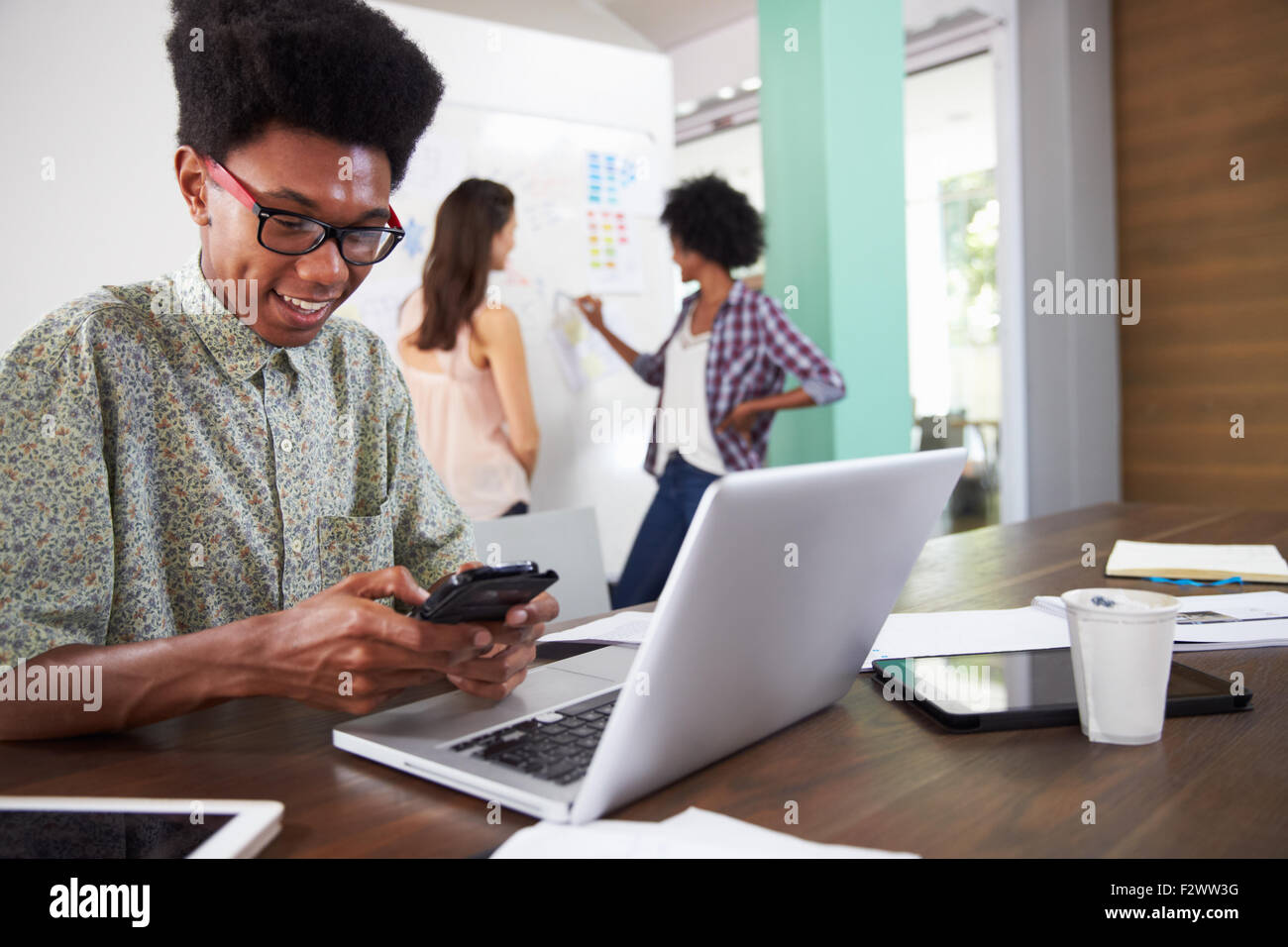 Three Businesspeople Having Creative Meeting In Office Stock Photo - Alamy