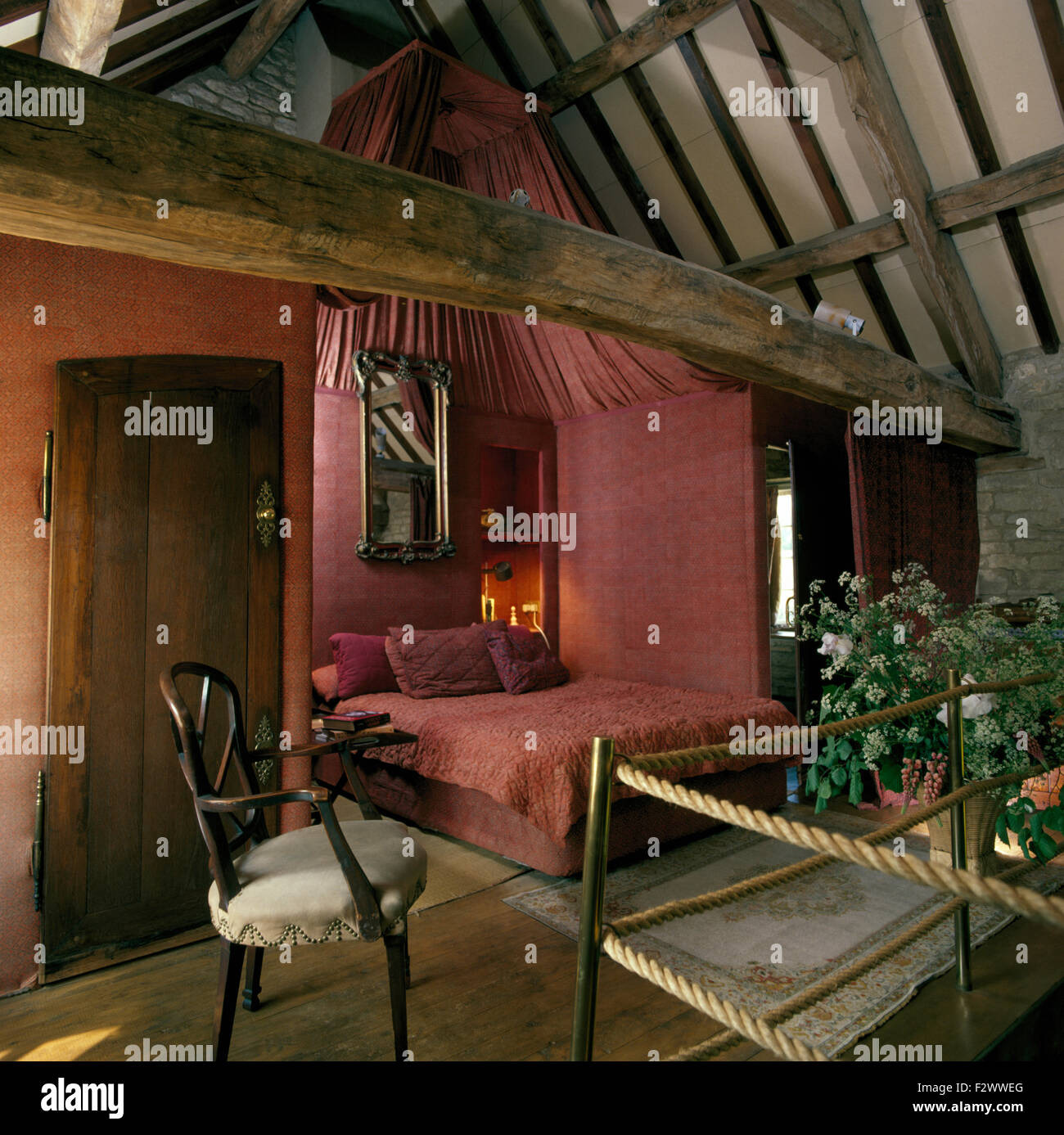 Pink Fabric On Walls In Open Plan Bedroom In Nineties Barn