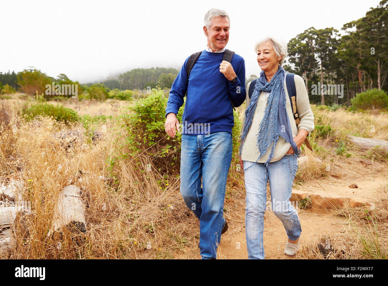 Senior couple walking together in a forest Stock Photo