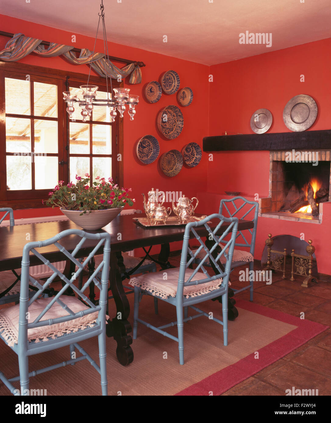 Pale Blue Painted Chairs At Dark Wood Table In Red Spanish Country Stock Photo Alamy