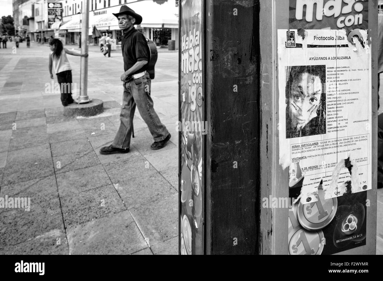Ciudad Juarez, Mexico. 28th Sep, 2014. Downtown Juarez and a vandalized poster on a phone booth asking for information on the disappearance of Iliana Carillo, who went missing in 2014 at the age of 23. (Credit Image: © Gabriel Romero/zReportage.com via ZUMA Press) Stock Photo