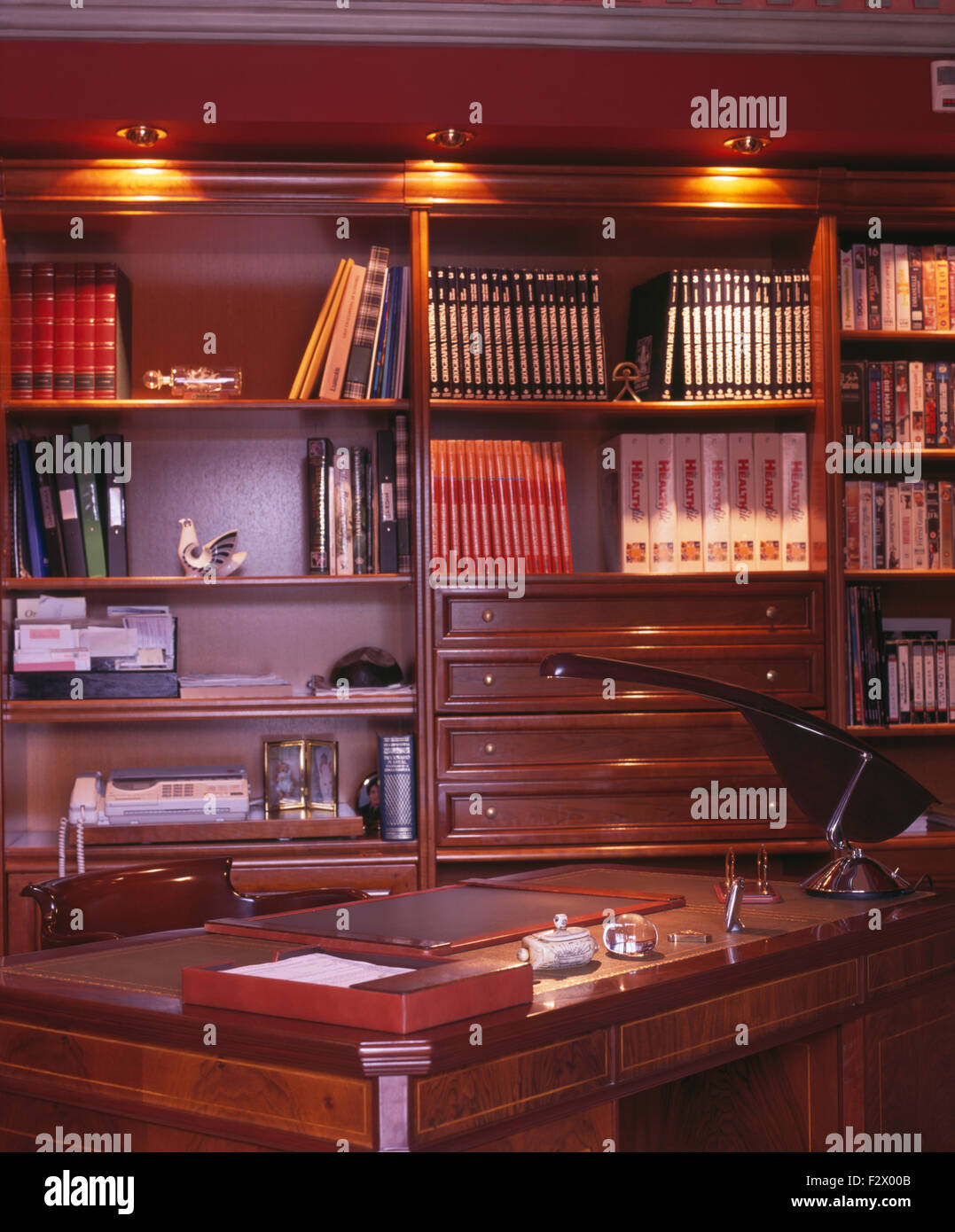 Downlighting above bookcases in Spanish study Stock Photo Alamy