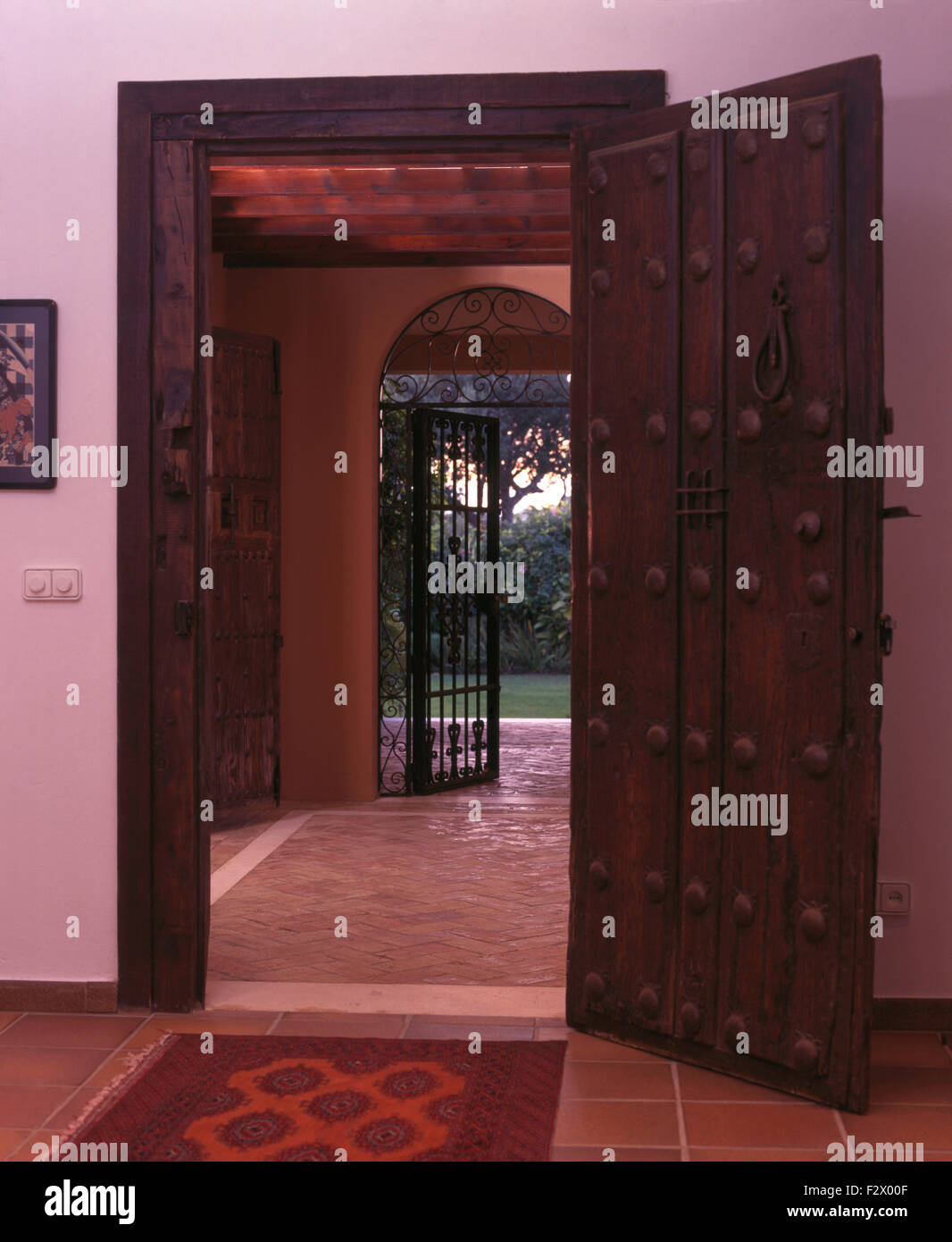 Carved wooden door in hallway of large Spanish country villa Stock
