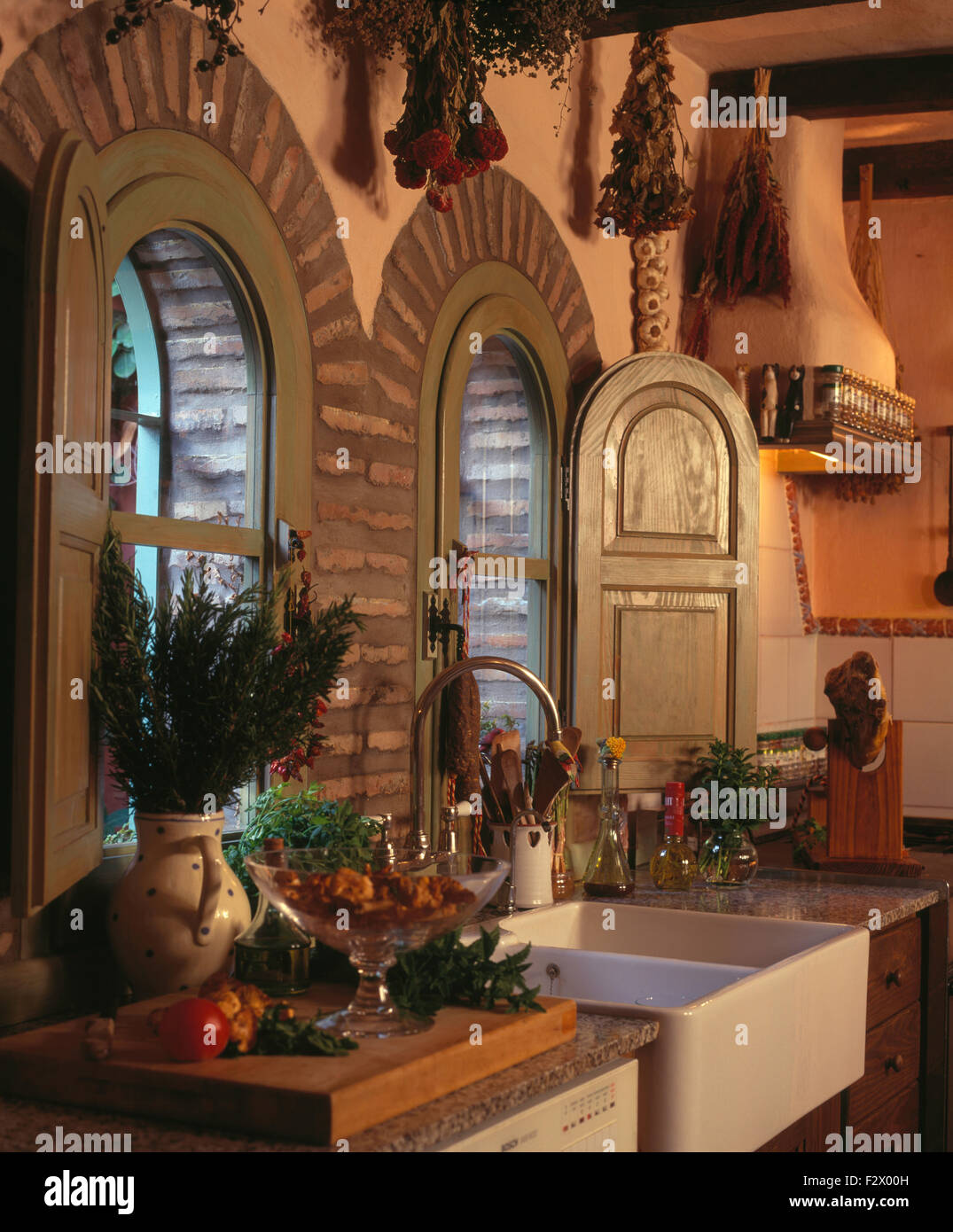 Wooden Shutters On Arched Windows Above Double Belfast Sink