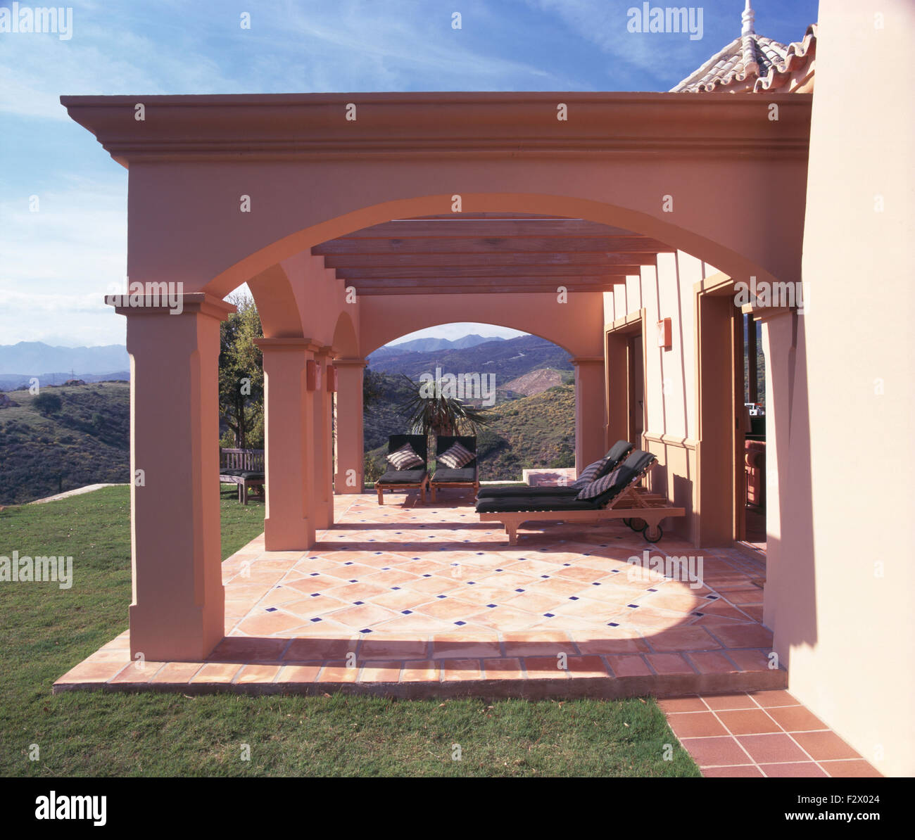 Exterior of a large newbuild Spanish villa with terracotta paving on