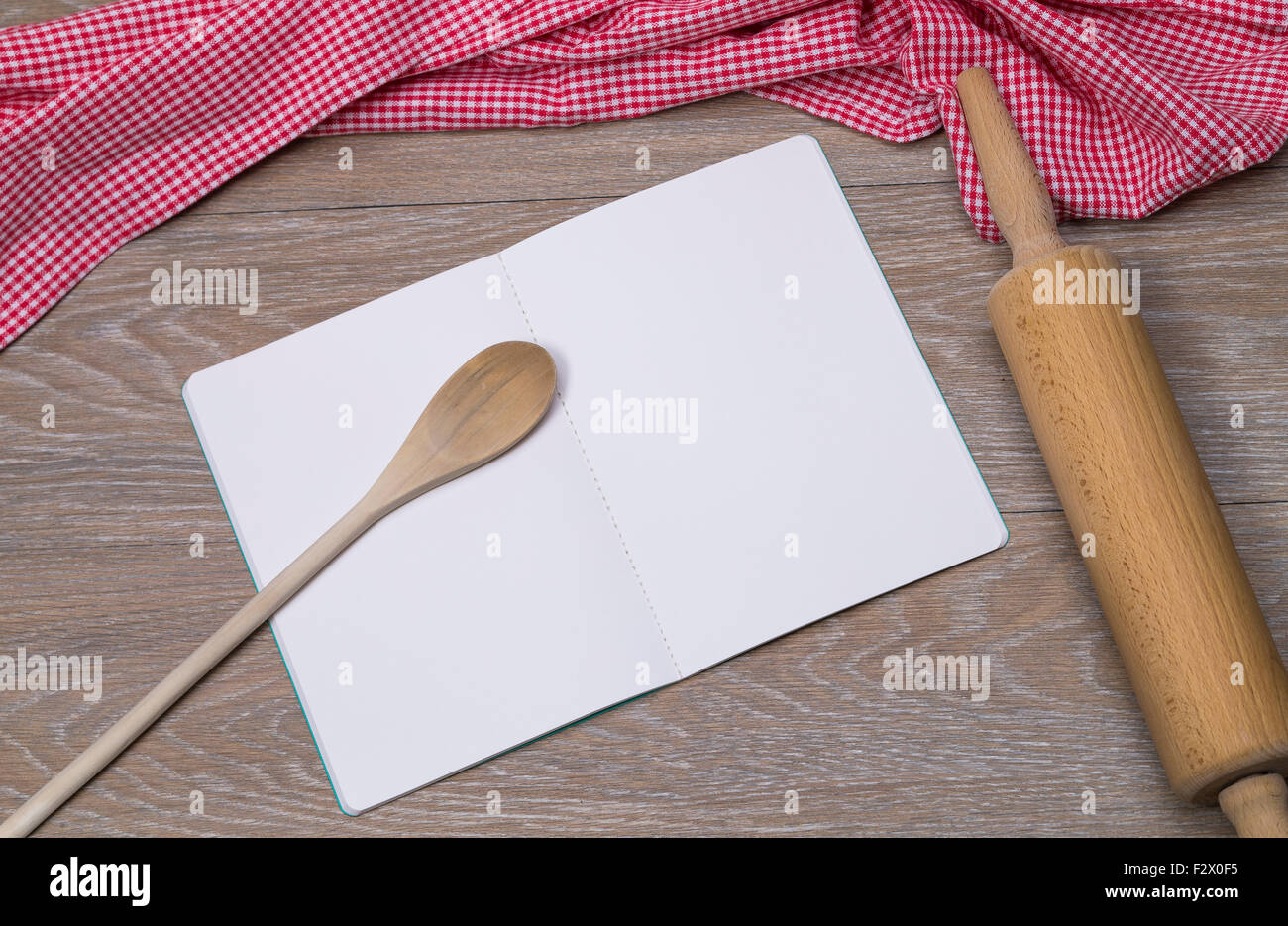 Image shows an open booklet with pen and rolling pin on a table Stock Photo