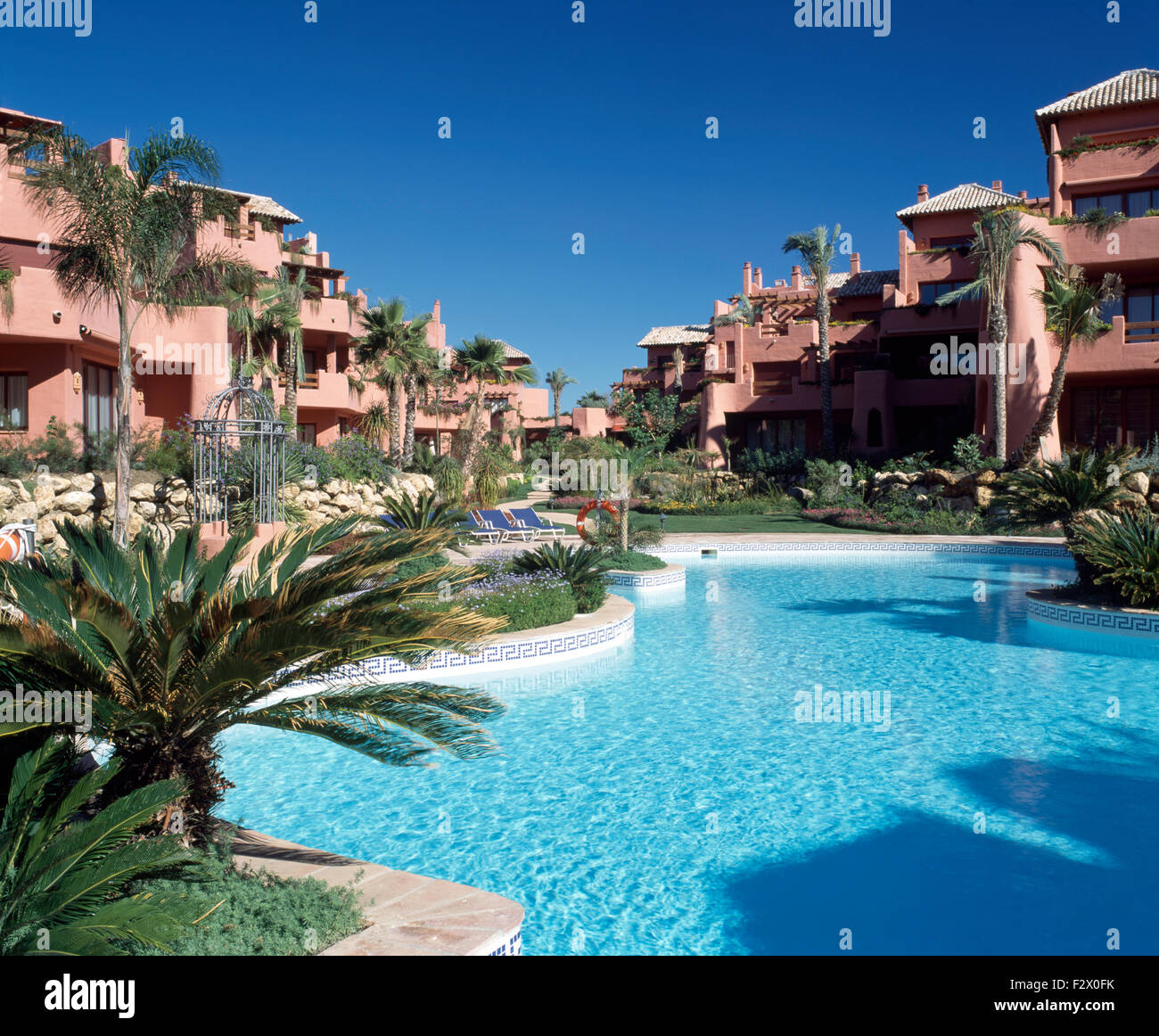Turquoise swimming pool in grounds of apartment buildings in Spanish