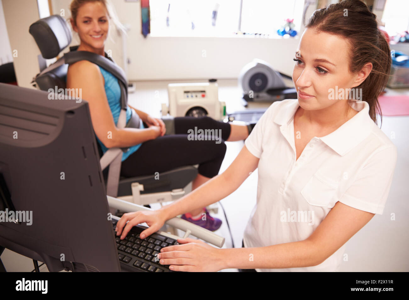 Female Patient Working With Physiotherapist In Hospital Stock Photo