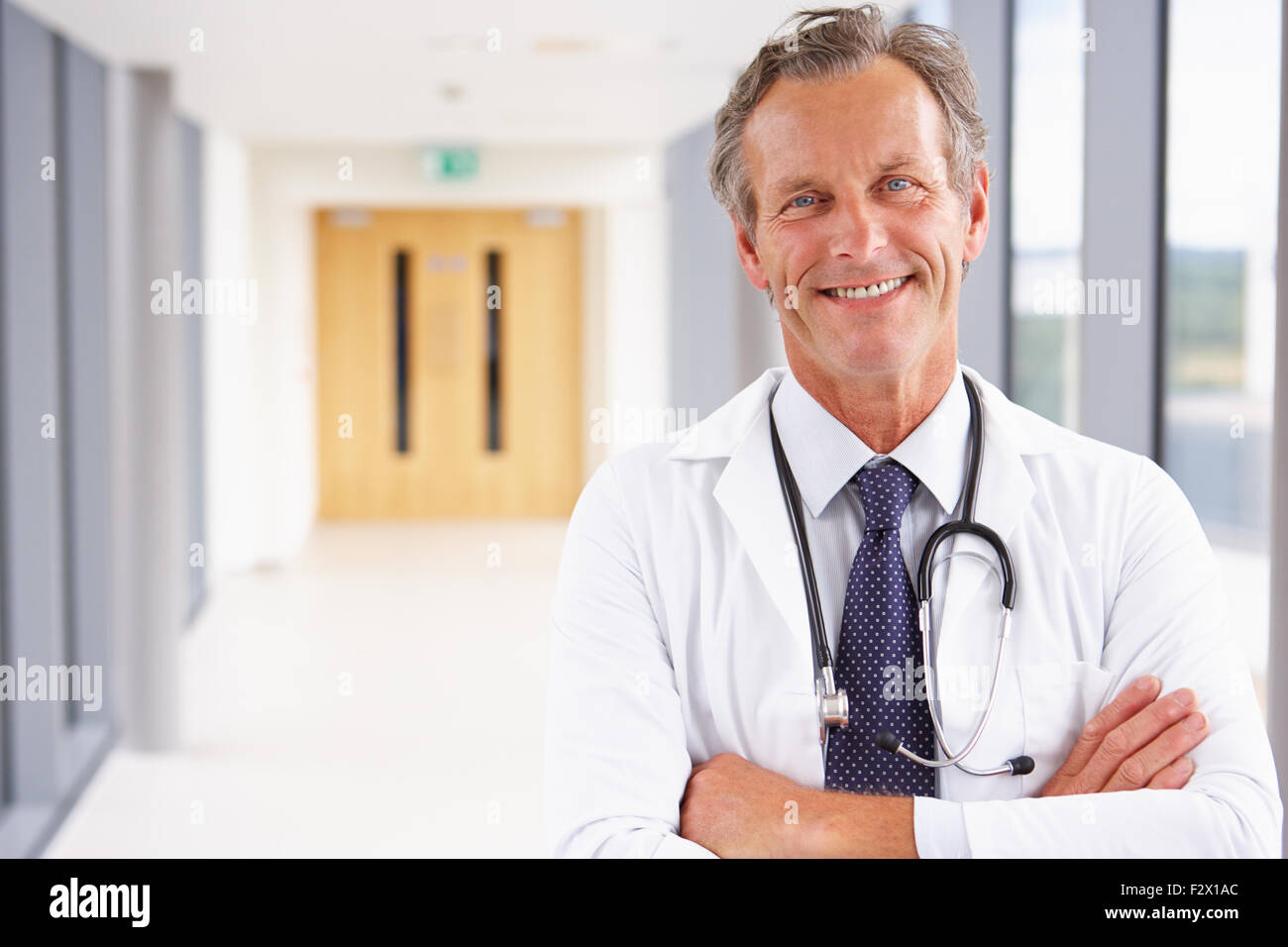 Portrait Of Male Doctor Standing In Hospital Corridor Stock Photo - Alamy