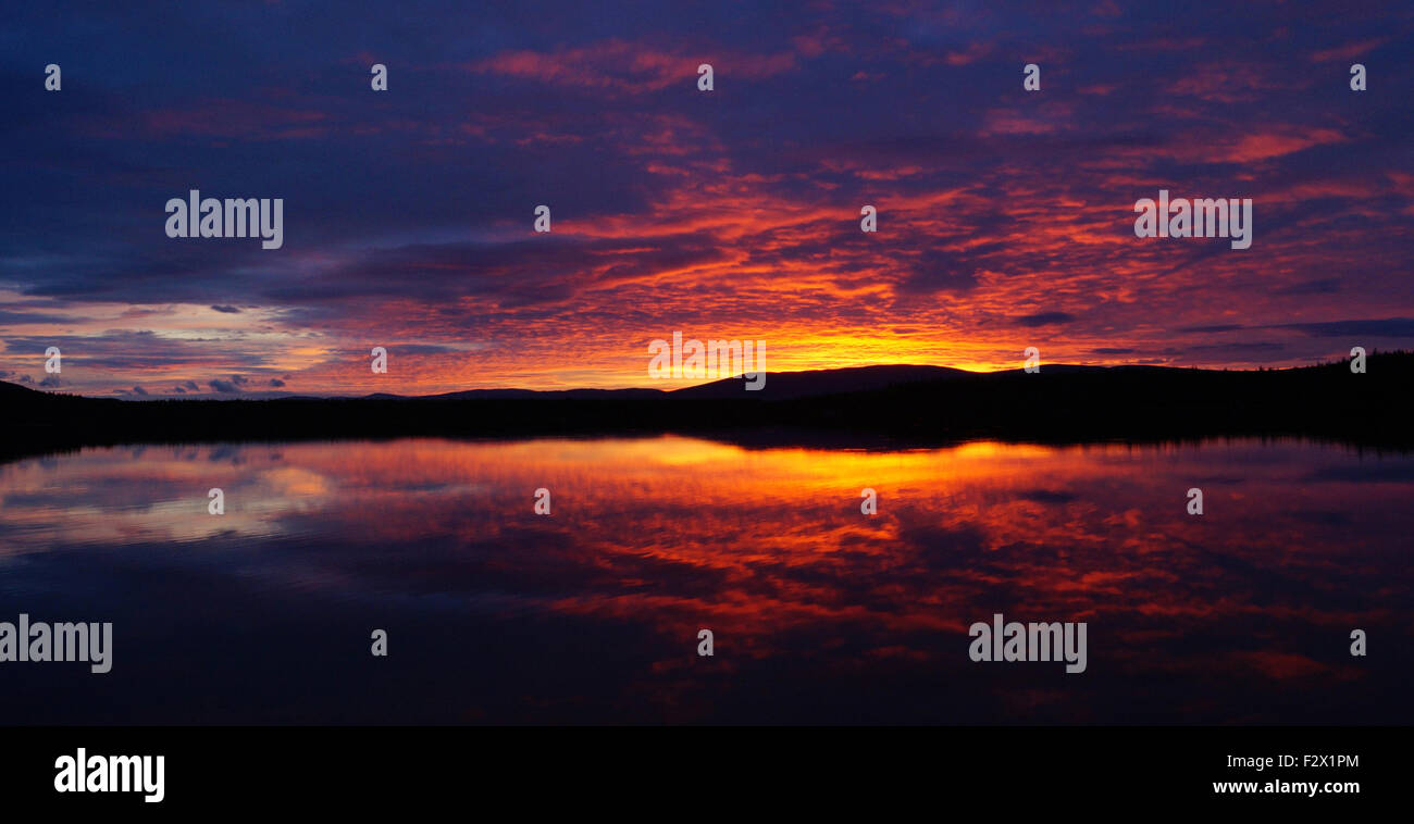 Loch Morlich Colorful Sunset clouds horizon landscape Stock Photo