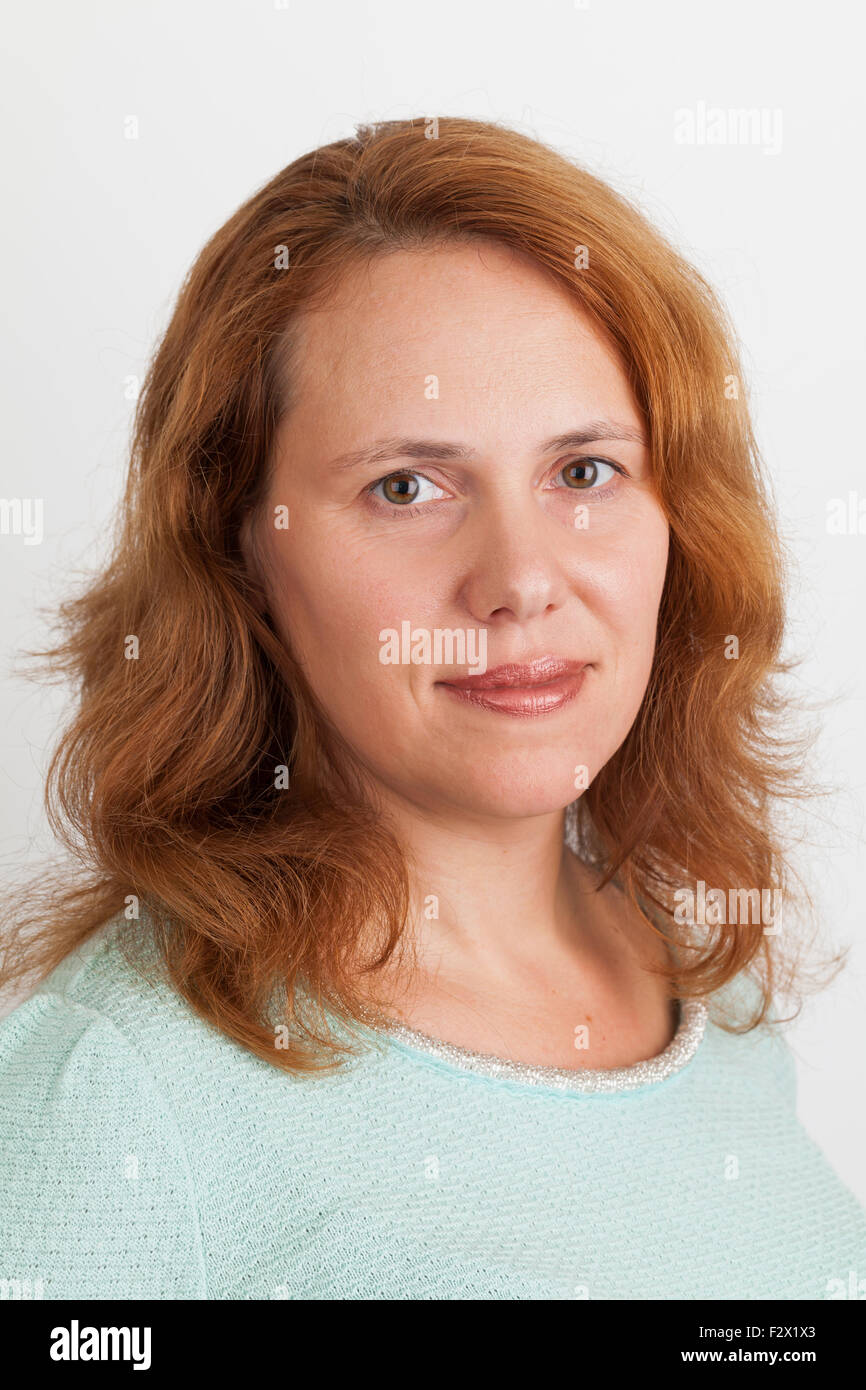 Young Caucasian woman, closeup studio portrait on light gray background Stock Photo