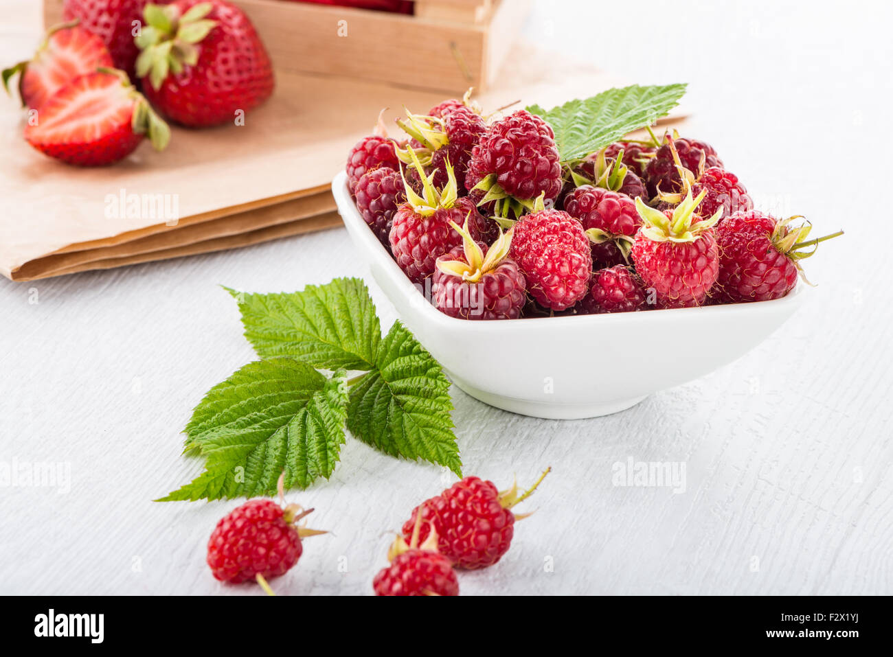 One Raspberry On A Table Fresh raspberry in a white bowl on wooden table Stock Photo - Alamy