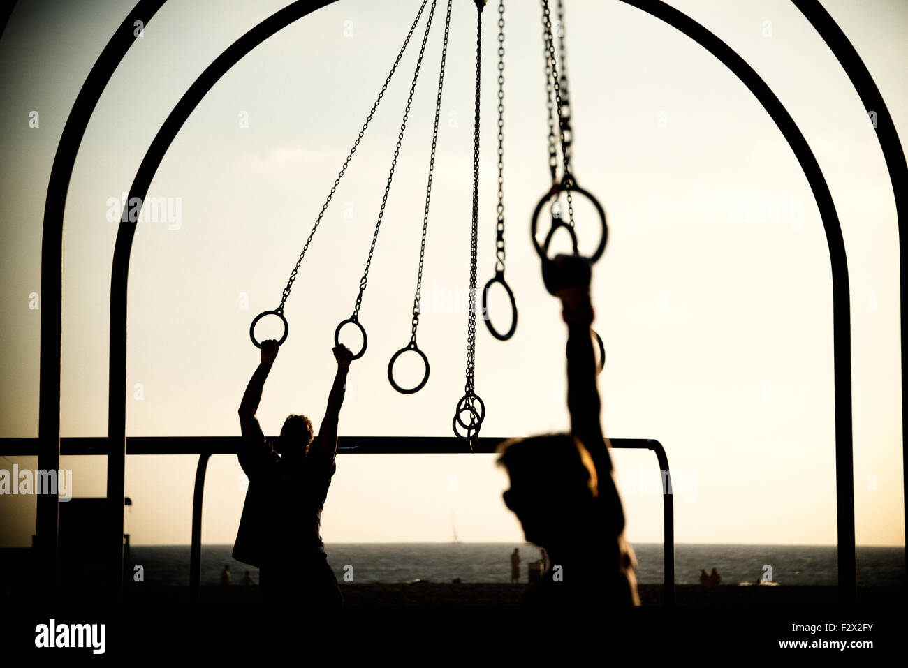 Tourists swinging on rings on the beach, Santa Monica Beach, Santa ...
