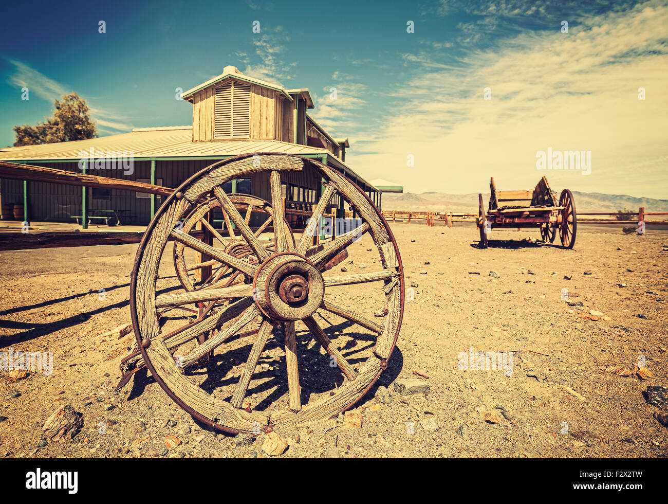 Retro style Western postcard with old carriages and saloon, Death Valley, USA. Stock Photo