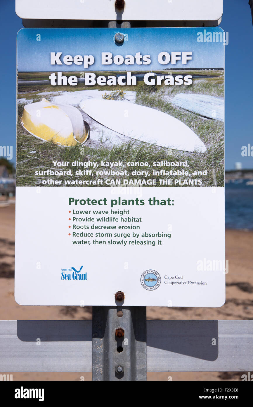 Sign saying to keep boats off of beach grass in order to protect beneficial beach grass. Stock Photo