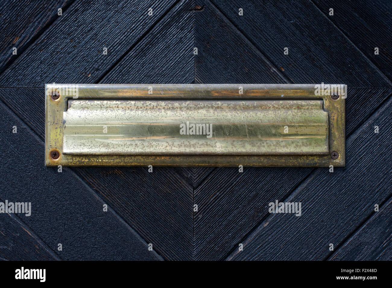 Brass mail slot in a black door Stock Photo Alamy