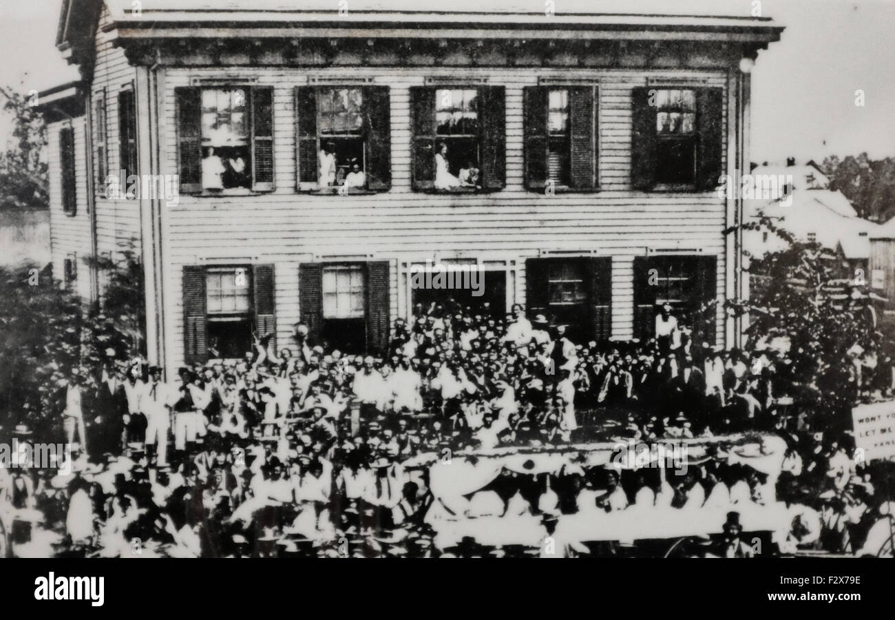 A Republican political parade stopped in front of the Lincoln home on August 8, 1860. A photographer captured the scene with Lincoln - in a white suit - standing to the right of the doorway Stock Photo
