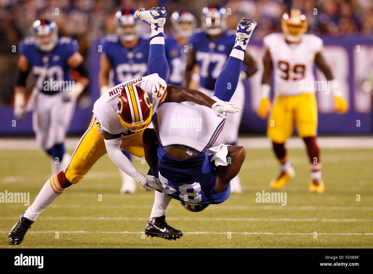 East Rutherford, New Jersey, USA. 24th September, 2015. New York Giants tight end Larry Donnell (84) gets flipped by Washington Redskins strong safety Trenton Robinson (34) after catching the ball during the NFL game between the Washington Redskins and the New York Giants at MetLife Stadium in East Rutherford, New Jersey. The New York Giants won 32-21. Christopher Szagola/CSM/Alamy Live News Stock Photo