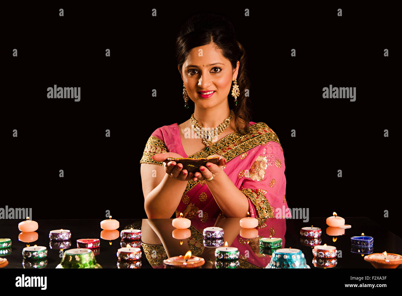 1 indian Adult Woman Diwali Festival Decoration  Diya Stock Photo