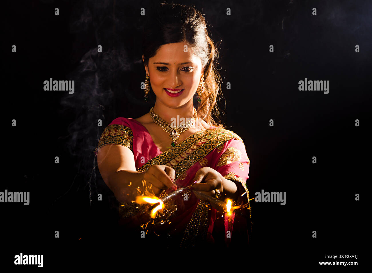 1 indian Adult Woman Diwali Festival Playing Fire Cracker Stock Photo