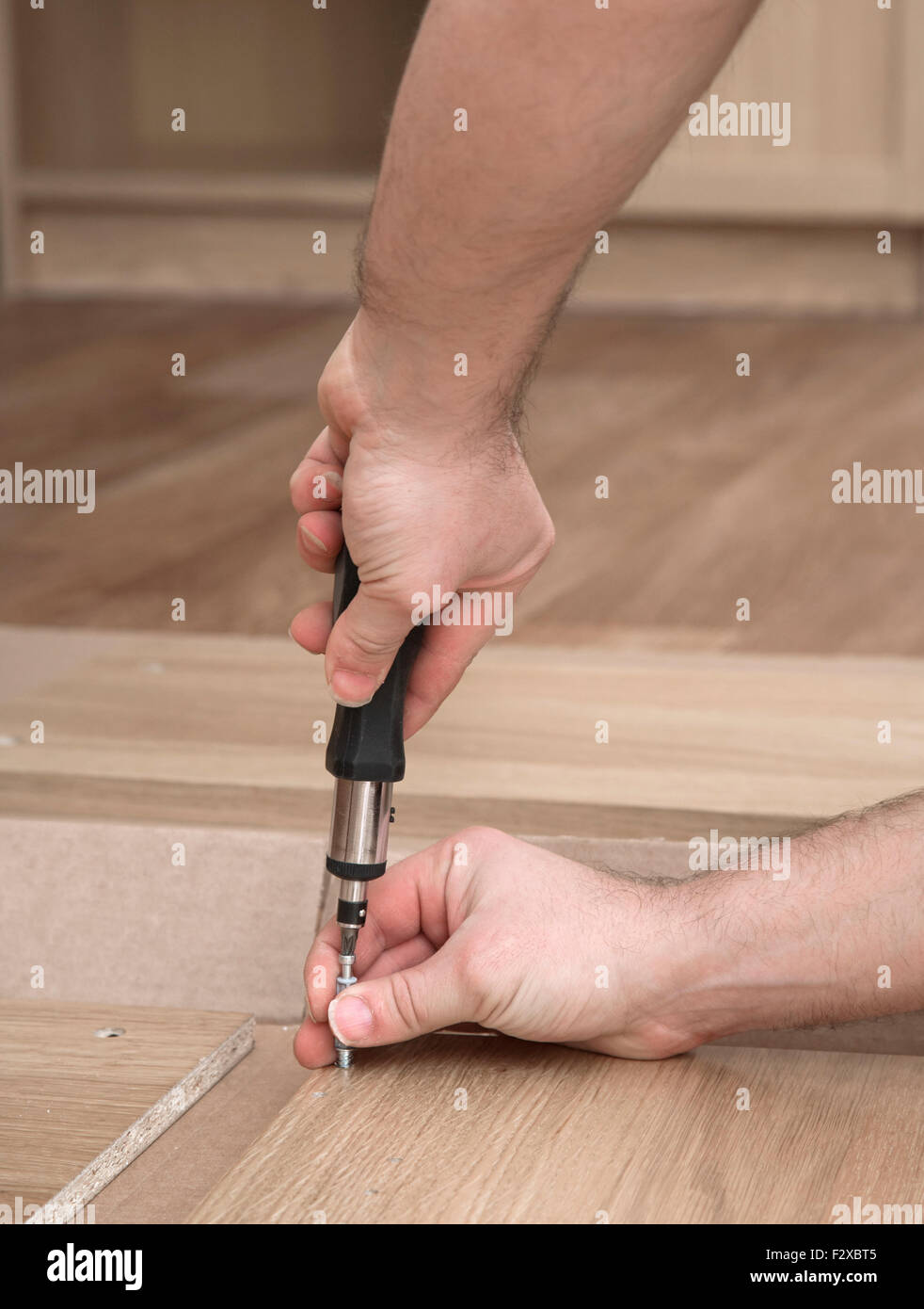 Hands with a screwdriver Stock Photo