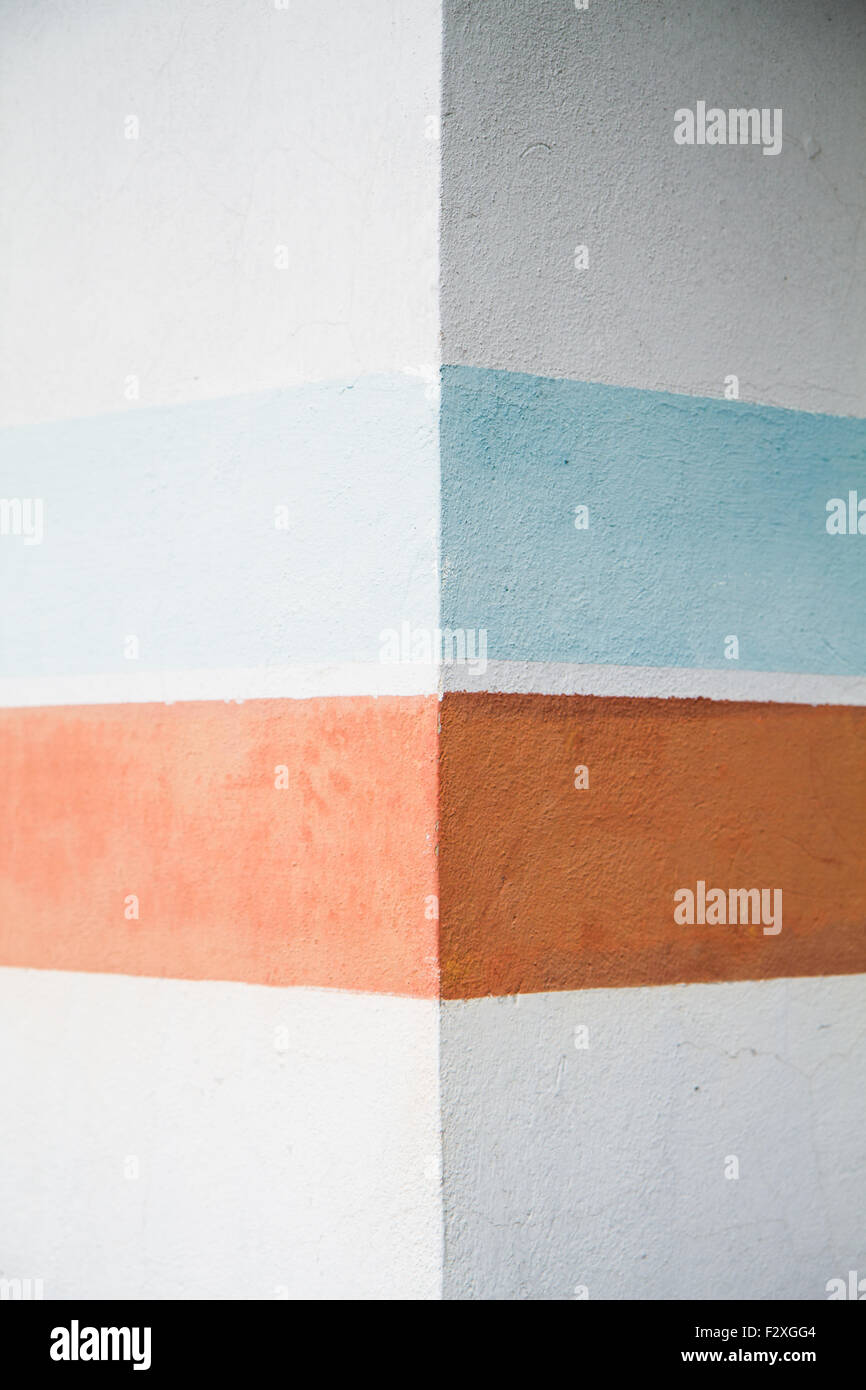 close up the wall with colored geometric patterns, ocher and blue Stock Photo