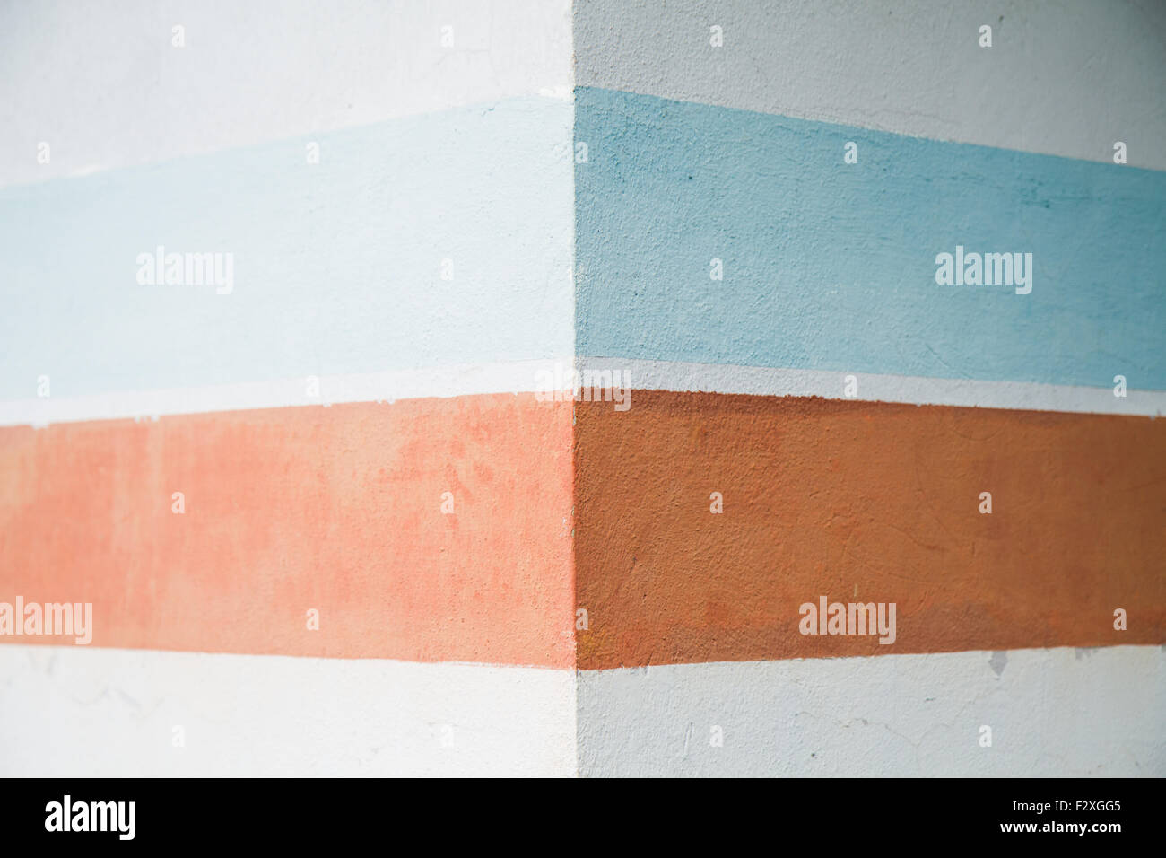 close up the wall with colored geometric patterns, ocher and blue Stock Photo