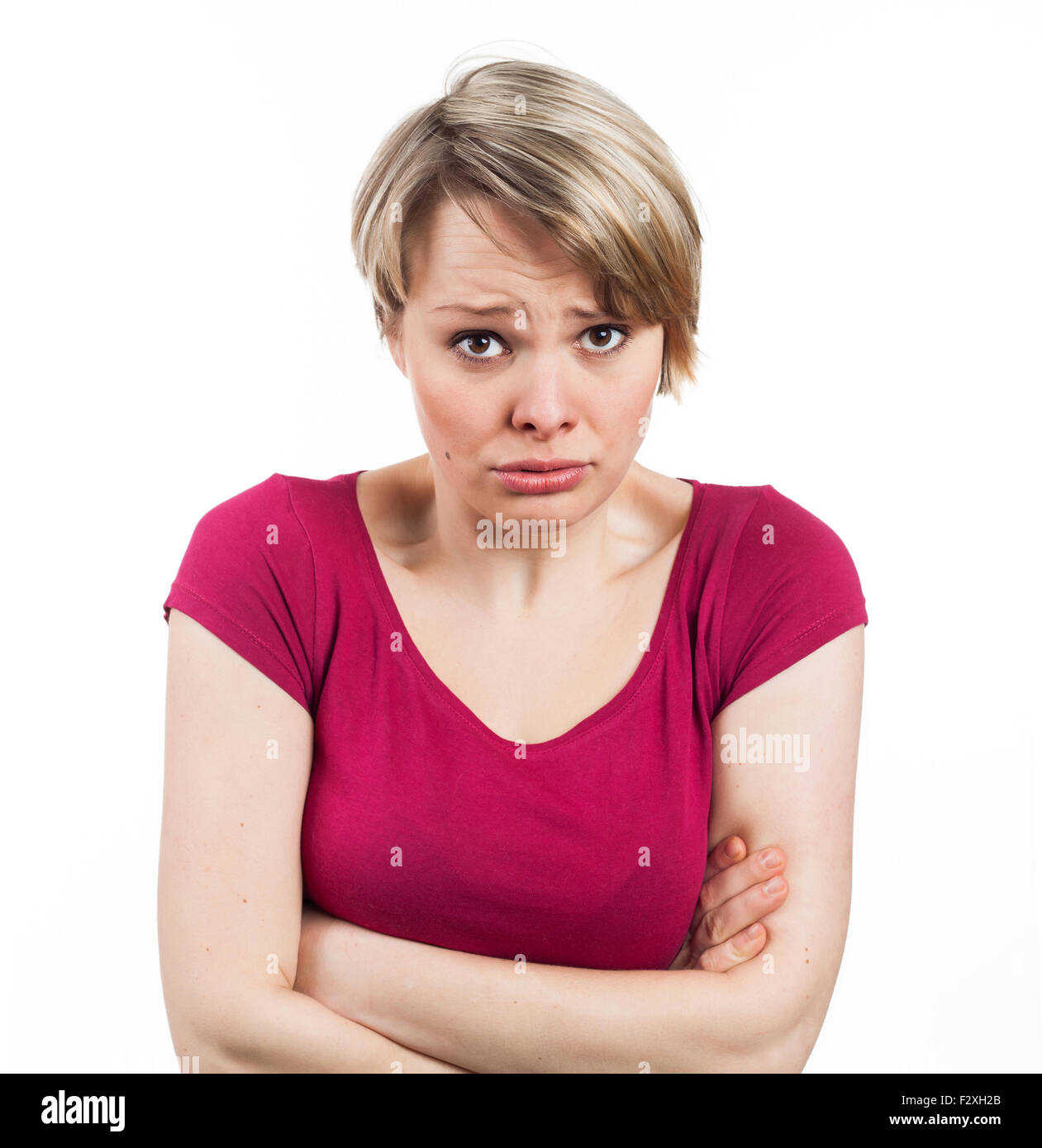 young woman appearing to be in an uncomfortable attitude, isolated on white Stock Photo