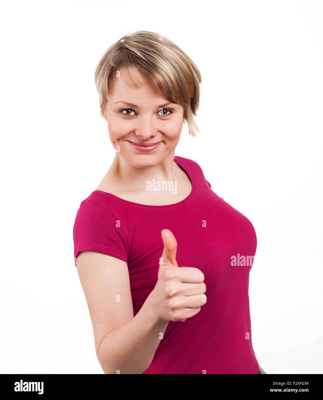 Young woman showing her thumb up and looking very confident, isolated on white Stock Photo