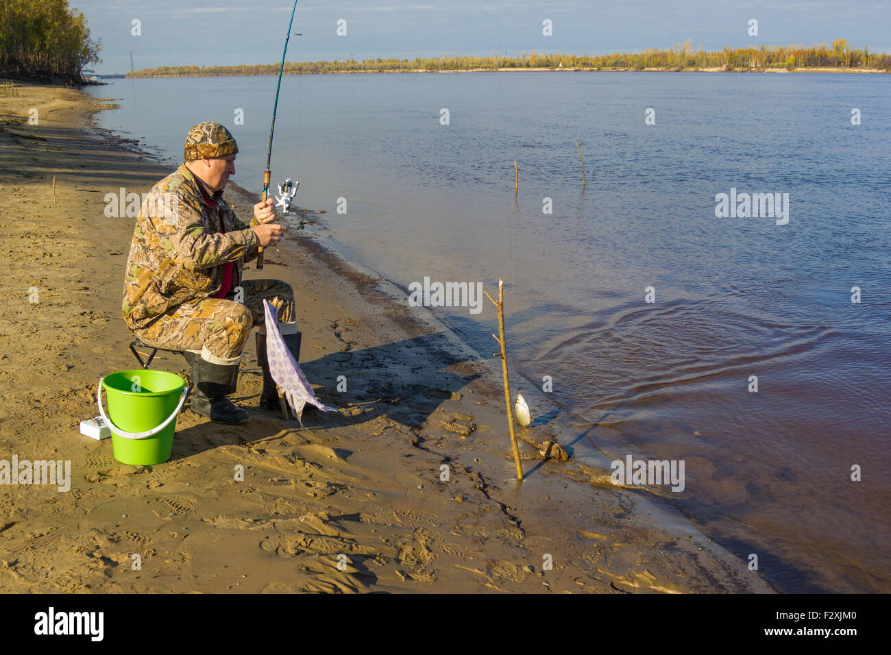Fisherman caught fishing rod on earthworm big roach Stock Photo - Alamy