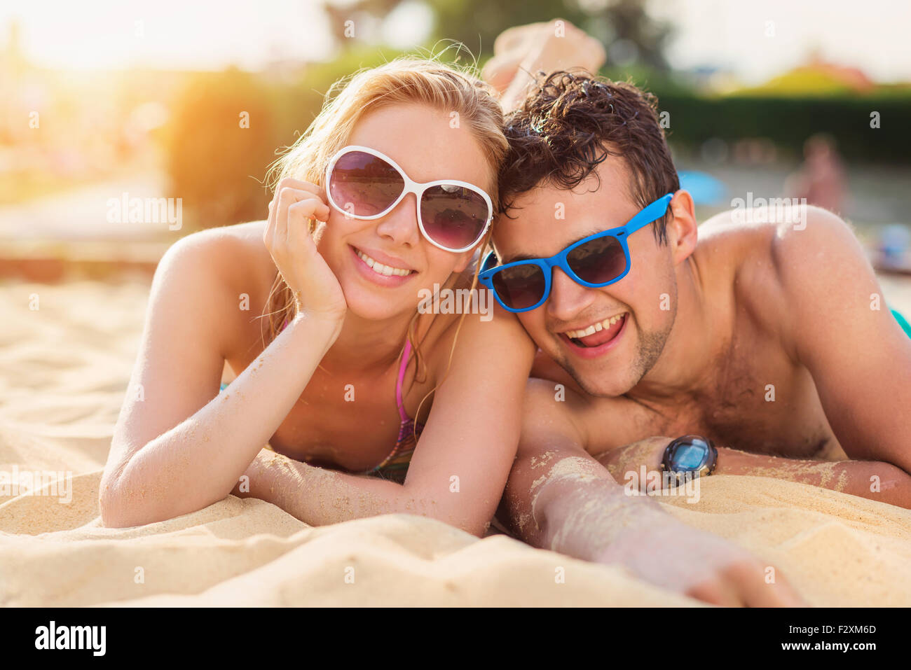Beautiful young couple having fun outside on the beach Stock Photo