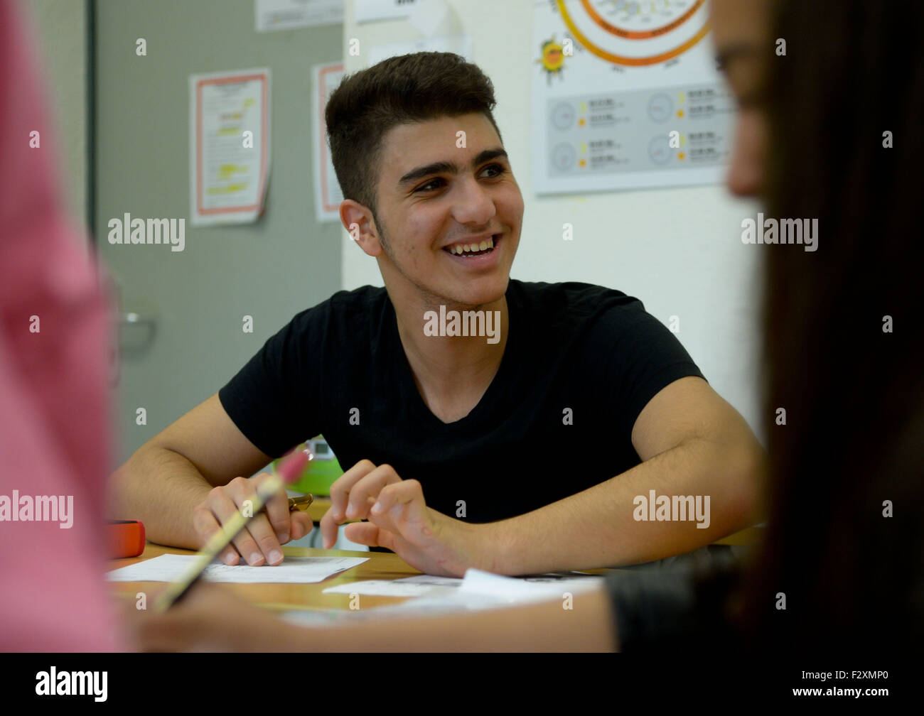 14-year-old Sikran from Iraq attends a German-language class at Hauptschule Peter Ustinov (Peter Ustinov secondary school) in Hanover, Germany, 23 September 2015. Around 20,000 to 30,000 young refugees are expected to arrive in Germany without their parents this year. The child protective services of the respective city they arrive in are responsible for their care. Photo: Peter Steffen/dpa Stock Photo