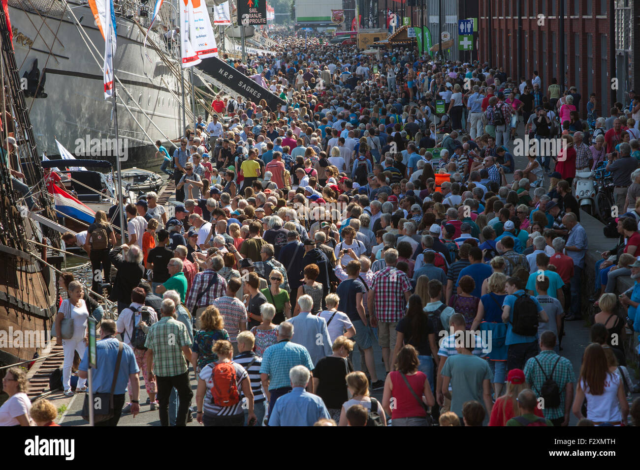 crowds visiting Sail 2015 in the ij-haven in Amsterdam. Stock Photo