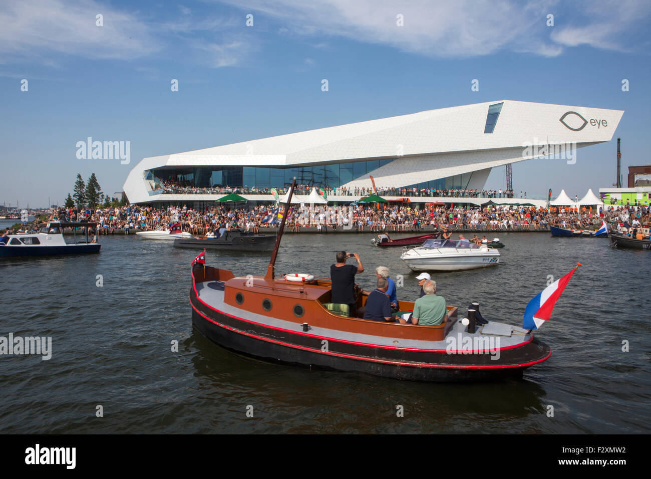 Boats at the Amsterdam canals during the 5 yearly Sail in 2015. in The background is cinema 'EYE' Stock Photo
