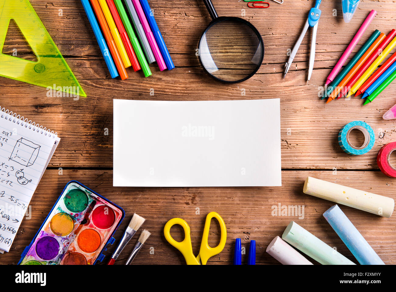Desk with school supplies. Studio shot on wooden background Stock Photo