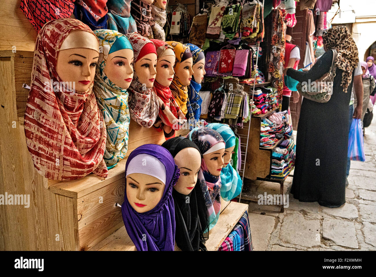Mannequins wearing hijab/alamira headscarfs outside shop in Fez medina, Morocco Stock Photo