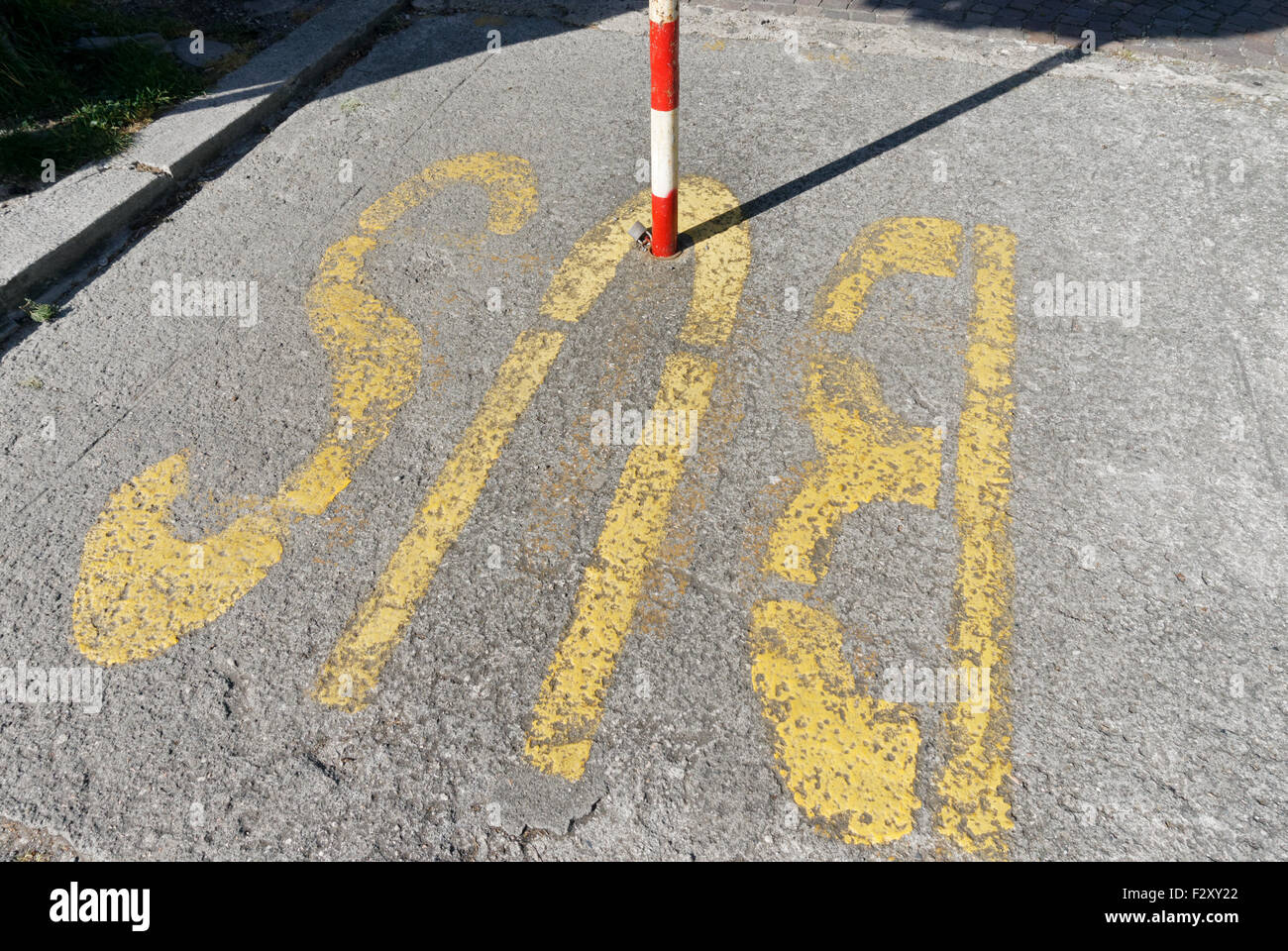 Bus Sign on the ground and marker post Stock Photo