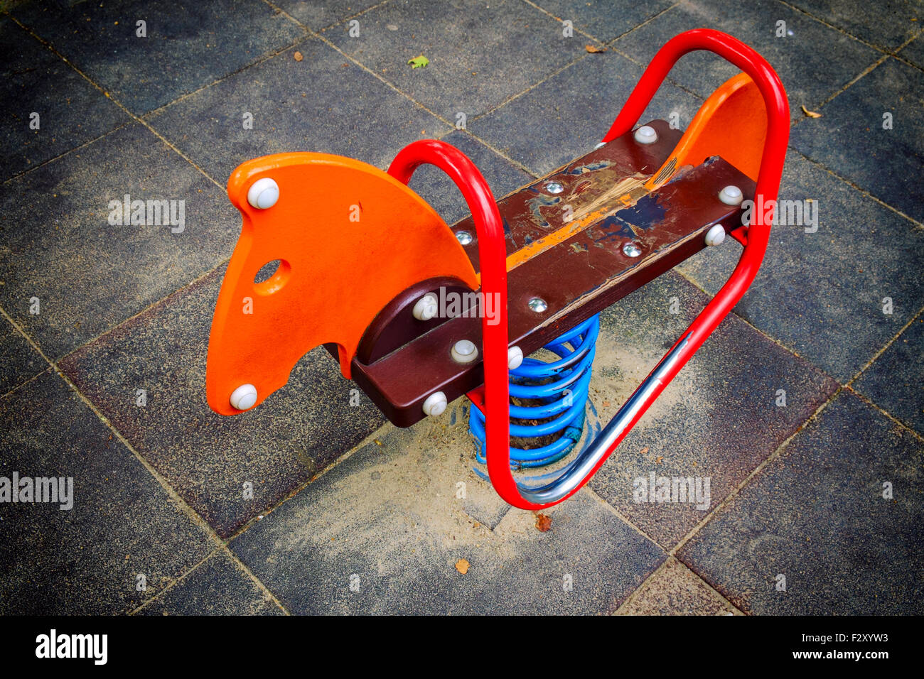 Empty horse swing in playground in city Stock Photo