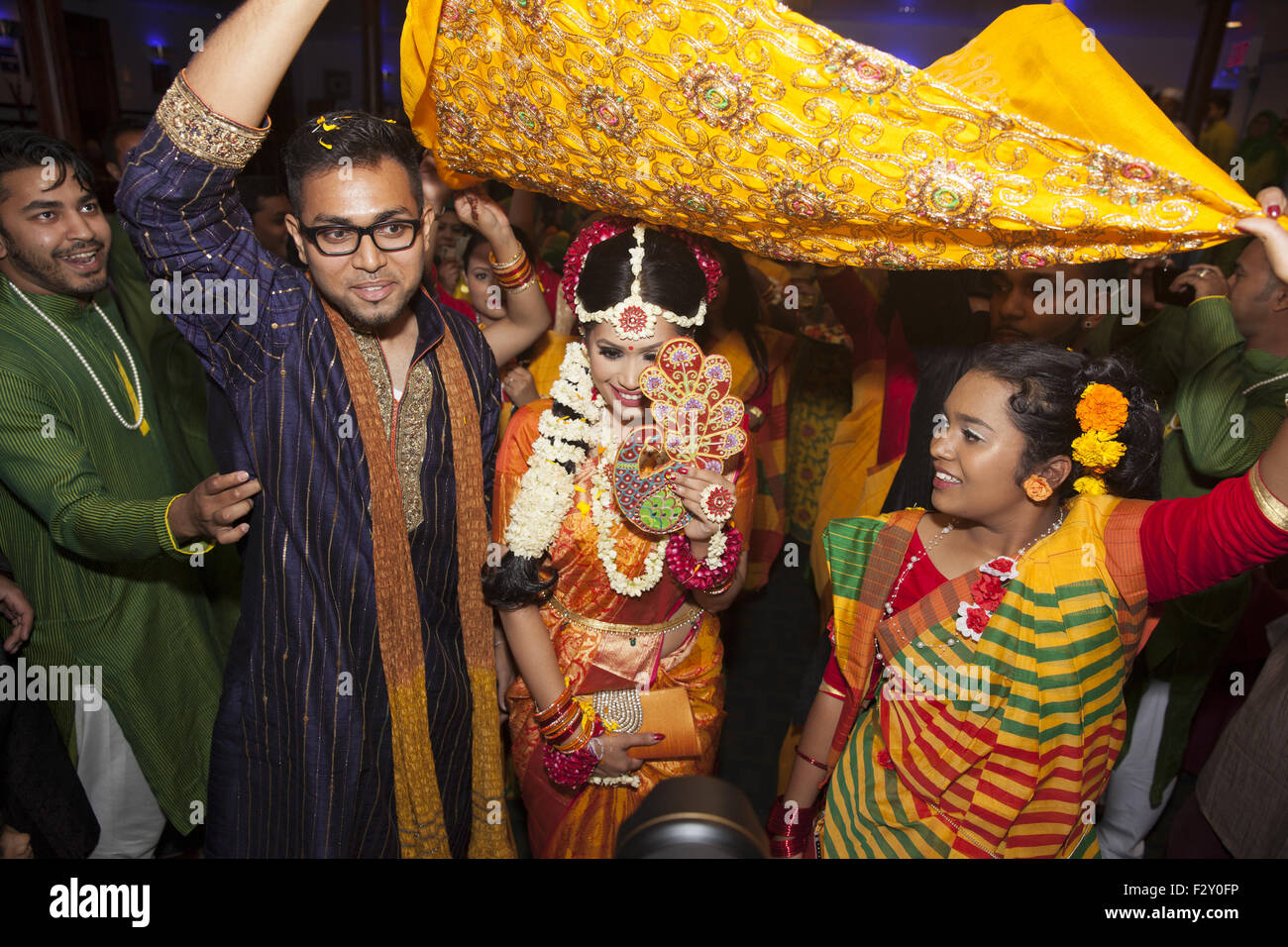Bride entering reception hall with family at a Bangladeshi wedding in Brooklyn, NY. Stock Photo