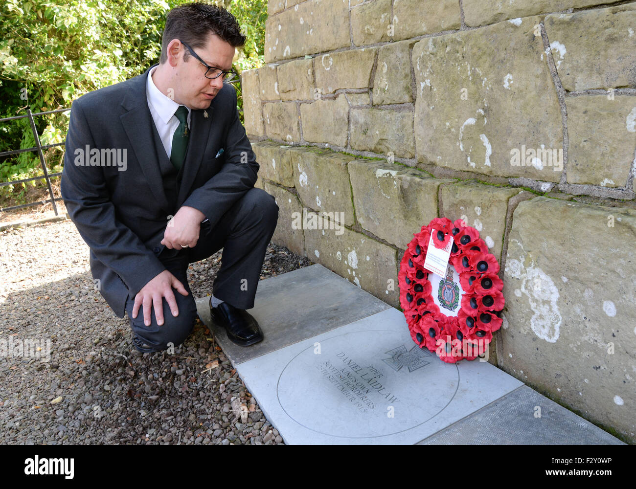 Swinton, UK. 25th Sep, 2015. Kevin Laidlaw studying the commerative VC Stone laid in honour of his Great Grandfather.   The Laying of the Commerative VC Stone in the small Scottish Border village of Swinton to mark the 100th Anniversary of the award of the Victoria Cross to Piper Daniel Laidlaw for his actions whilst serving with the 7th Battalion of the King's Own Scottish Borderers.   Daniel Logan Laidlaw was born at Little Swinton, Berwickshire on 26 July 1875 and joined the Army in 1896. Stock Photo
