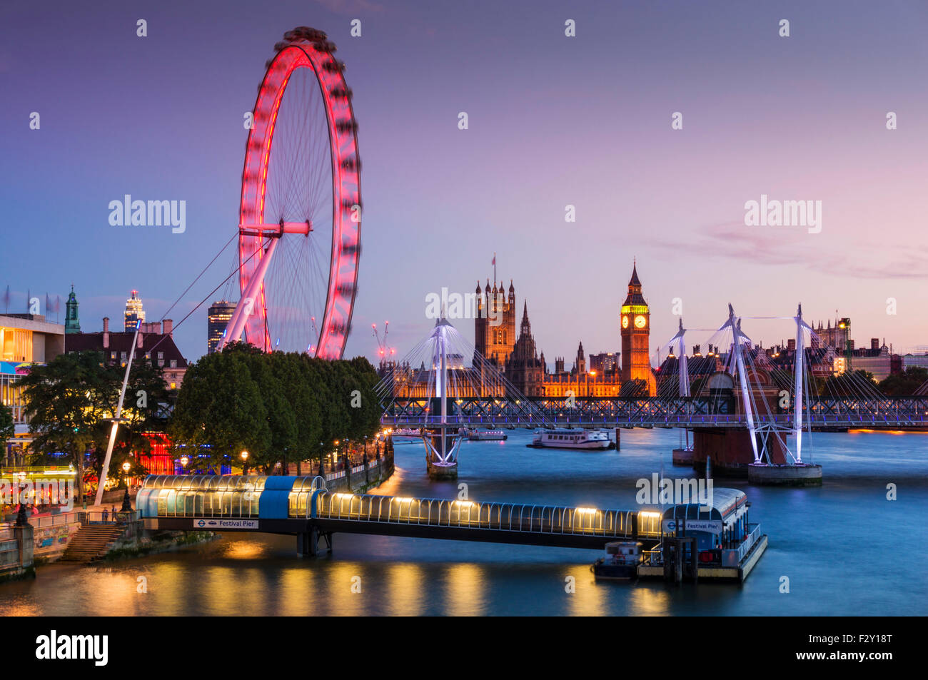 London skyline with London Eye and houses of parliament on the River Thames at night London England GB UK Europe Stock Photo