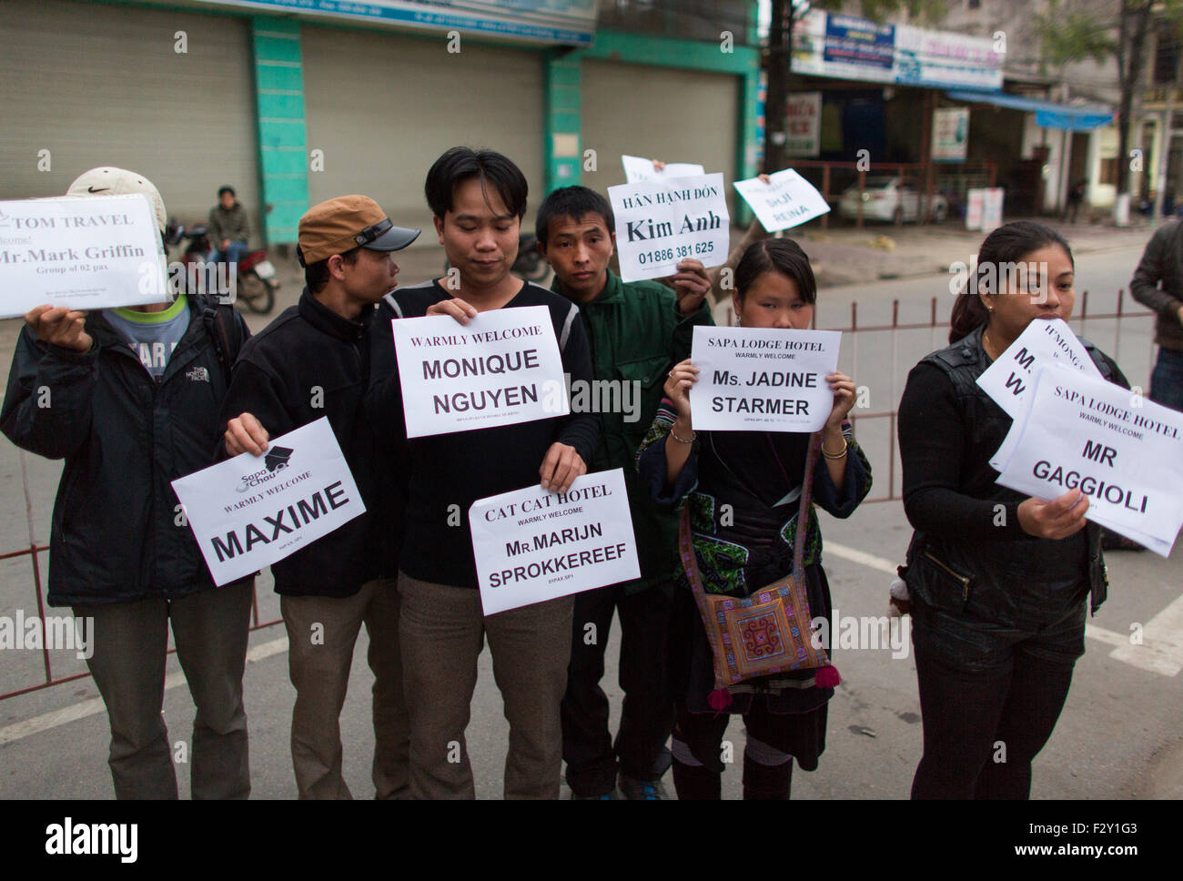 guides awaiting tourists at the train station in Northern Vietnam Stock Photo