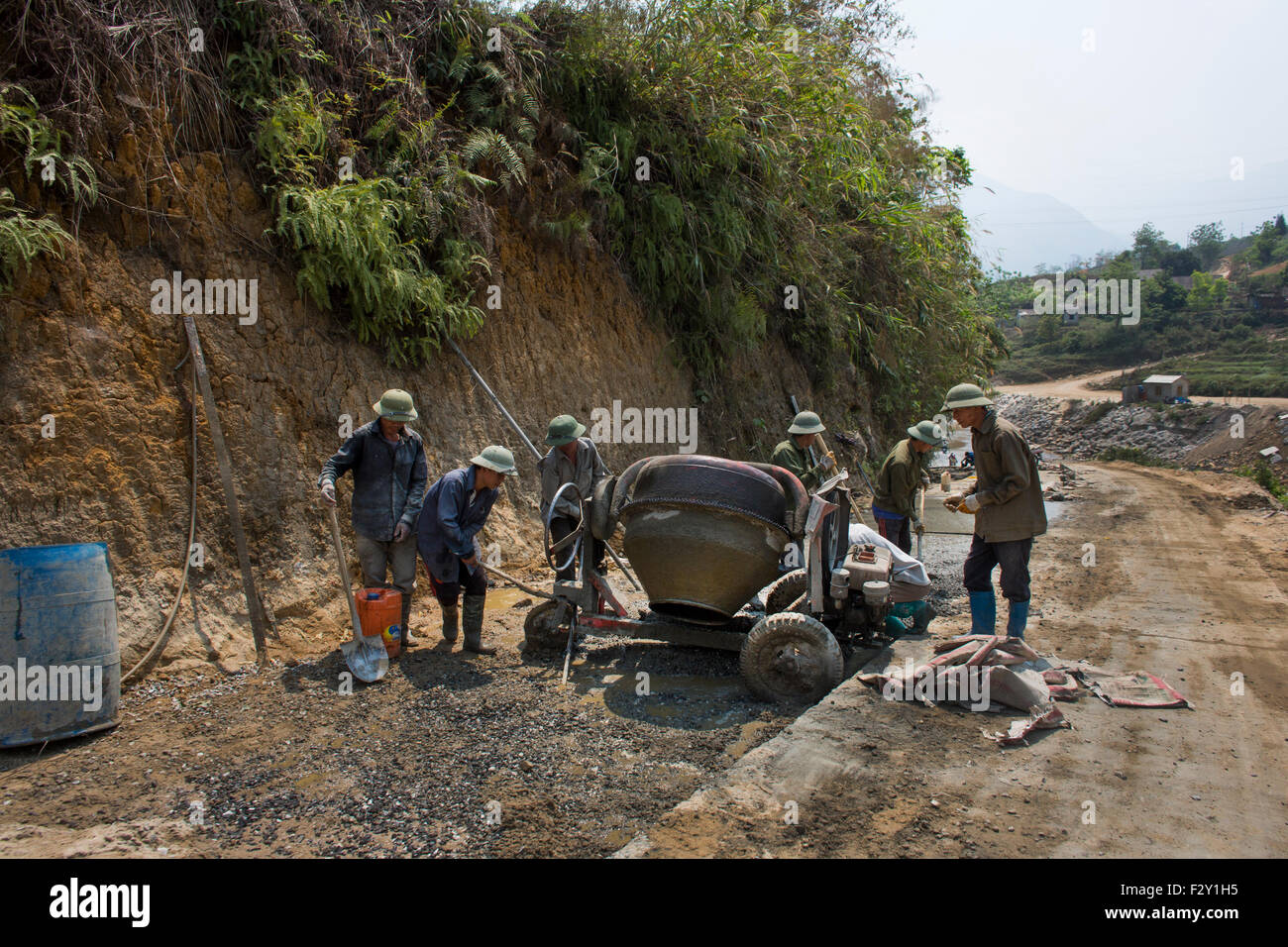 Vietnamese road workers building a new road Stock Photo